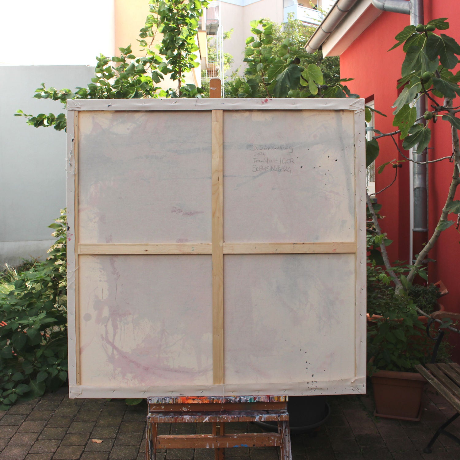 A painting with pink and blue paint splatters on a white background.