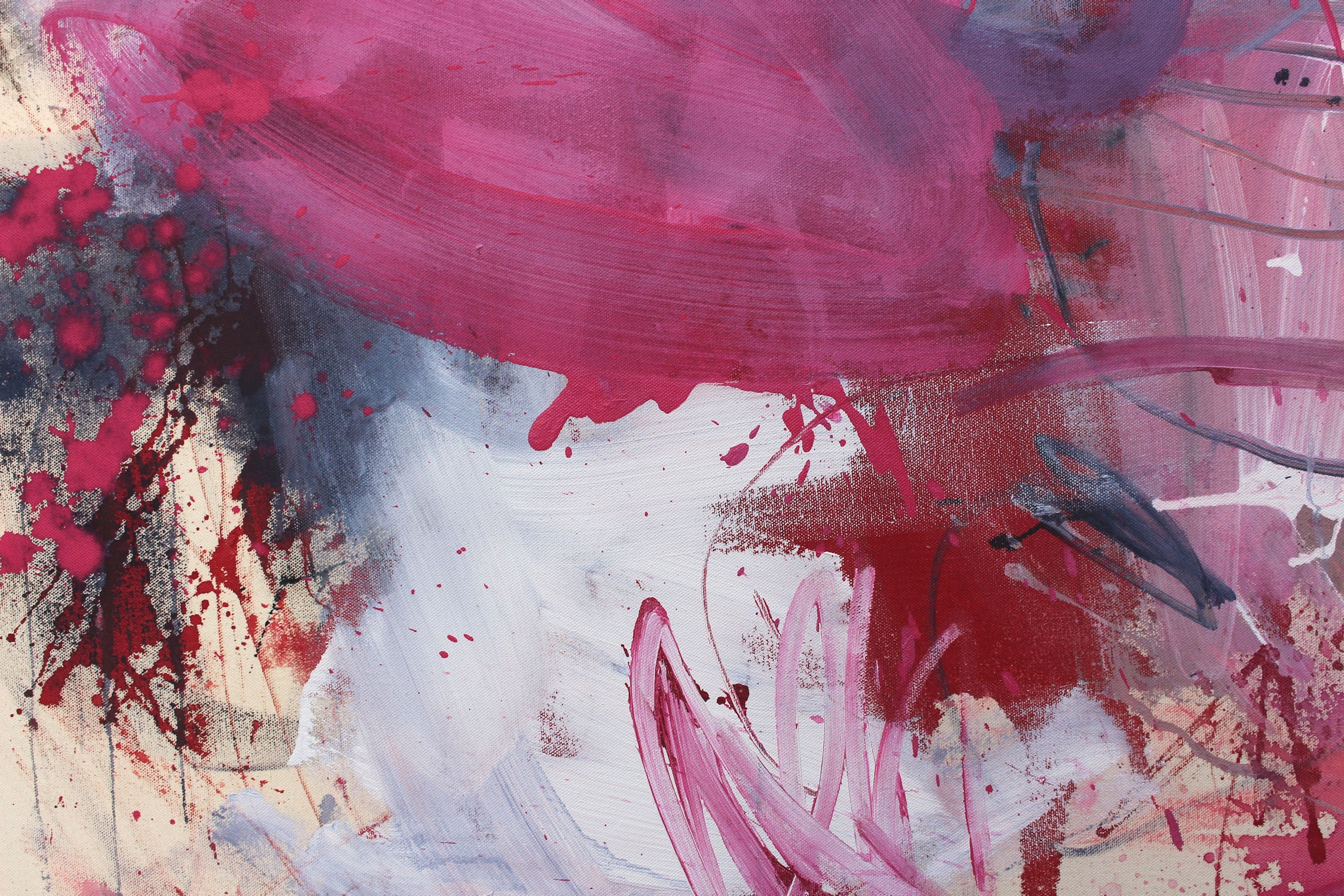 A painting with pink and blue paint splatters on a white background.