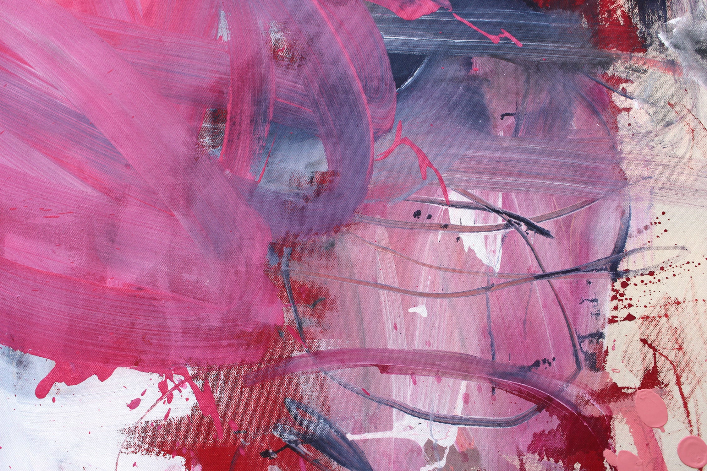 A painting with pink and blue paint splatters on a white background.