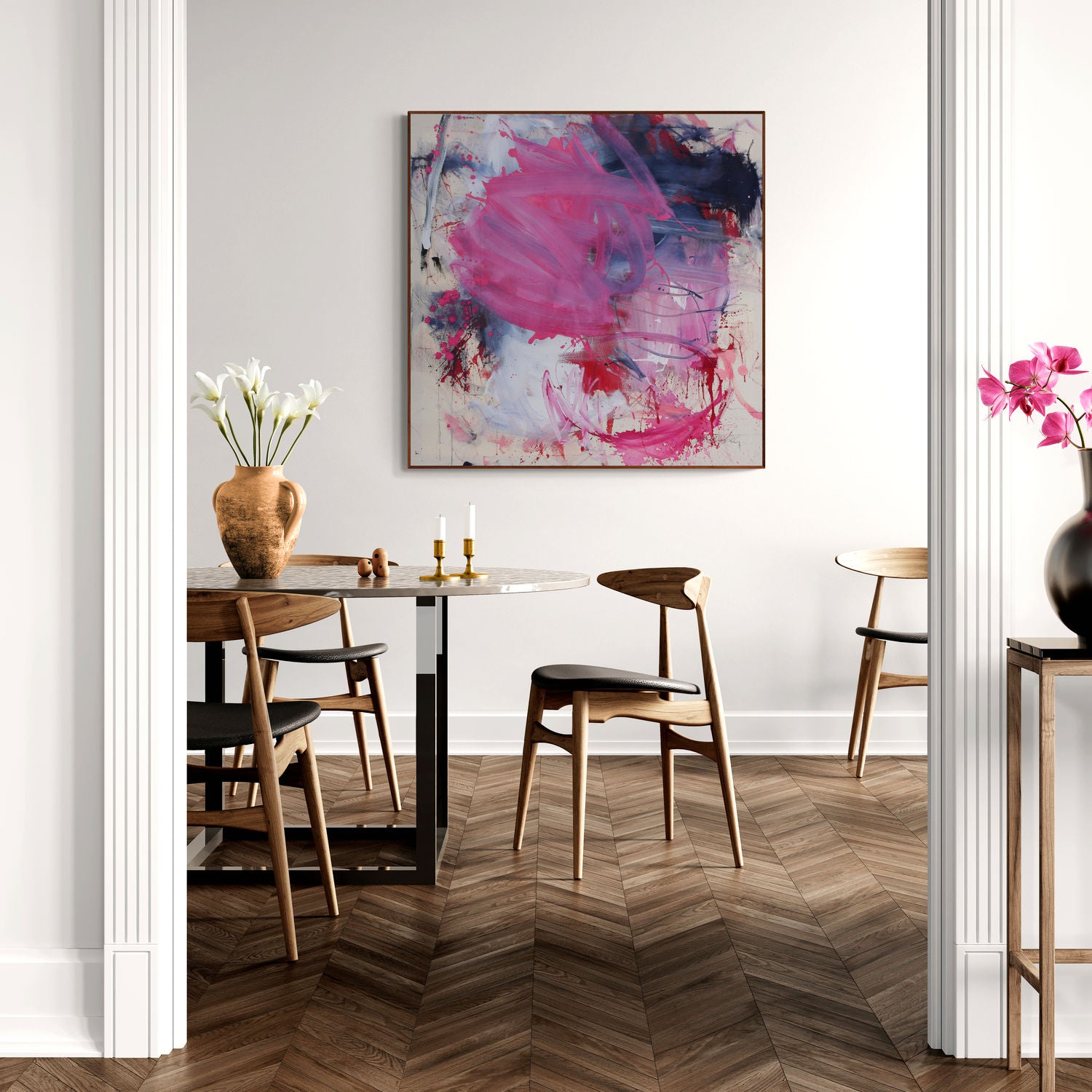 A painting with pink and blue paint splatters on a white background.