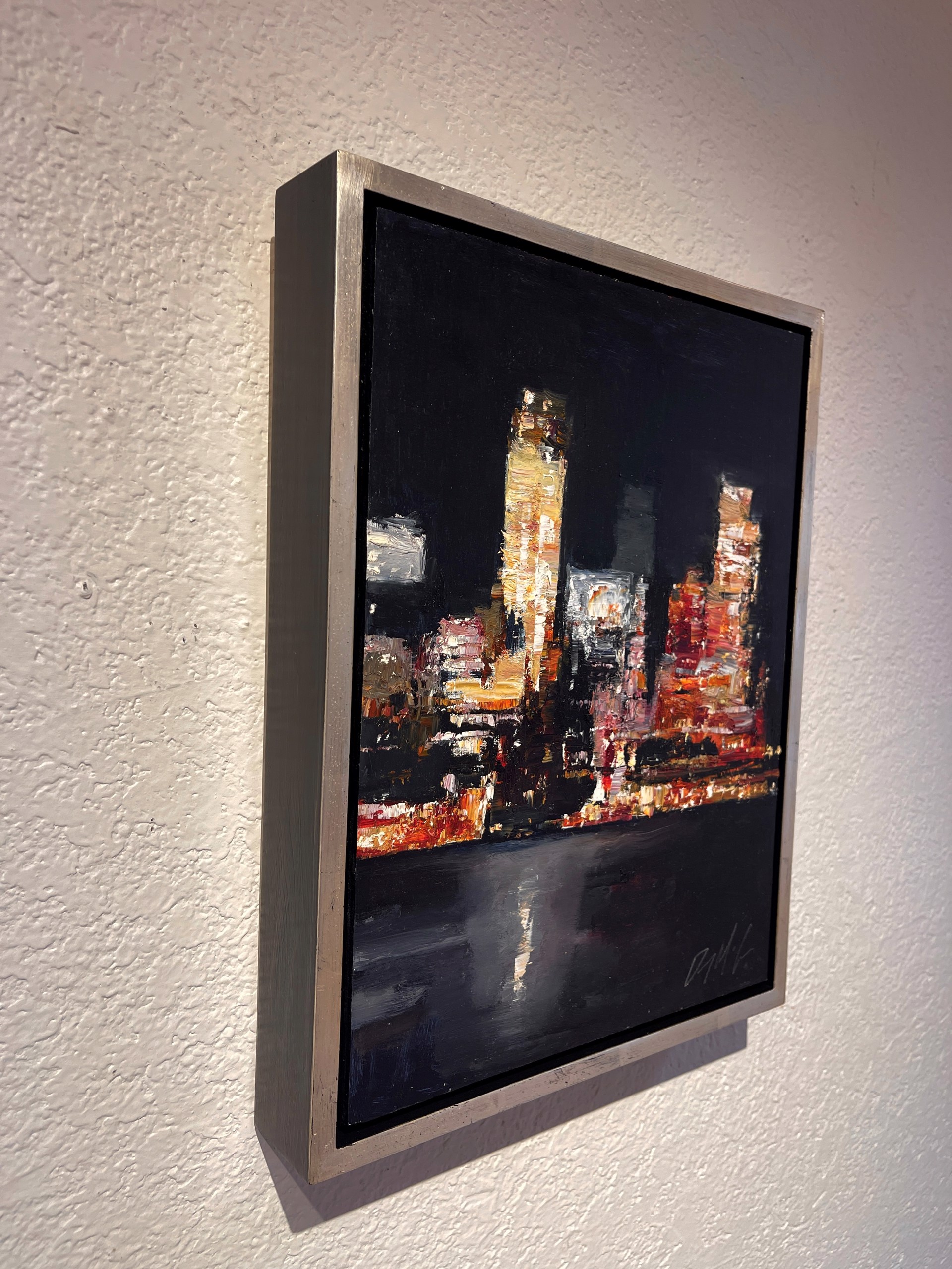 A nocturnal cityscape rendered in thick, expressive brushstrokes with a palette of warm oranges and deep blacks.