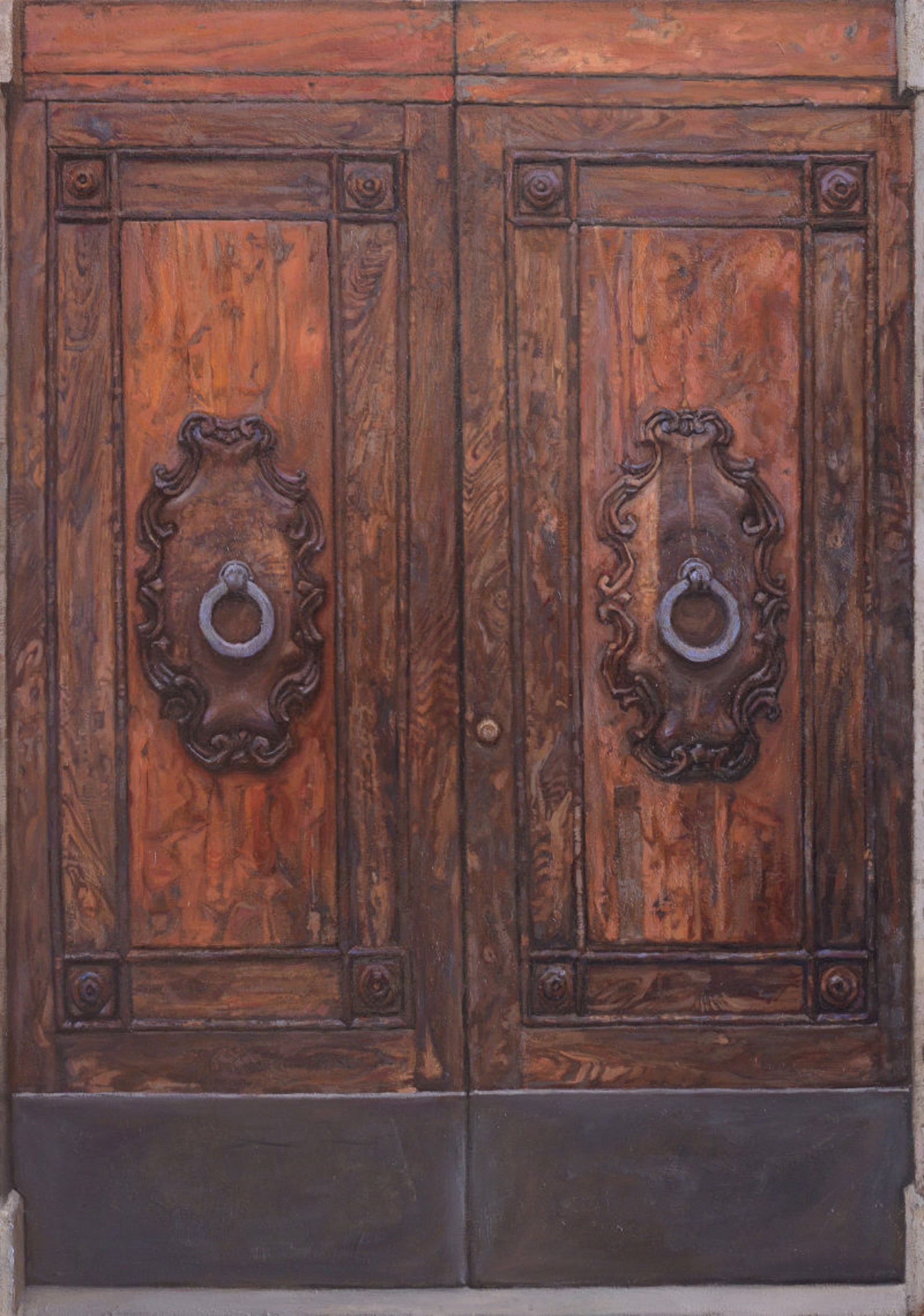 A pair of ornate wooden double doors featuring carved metal knockers.