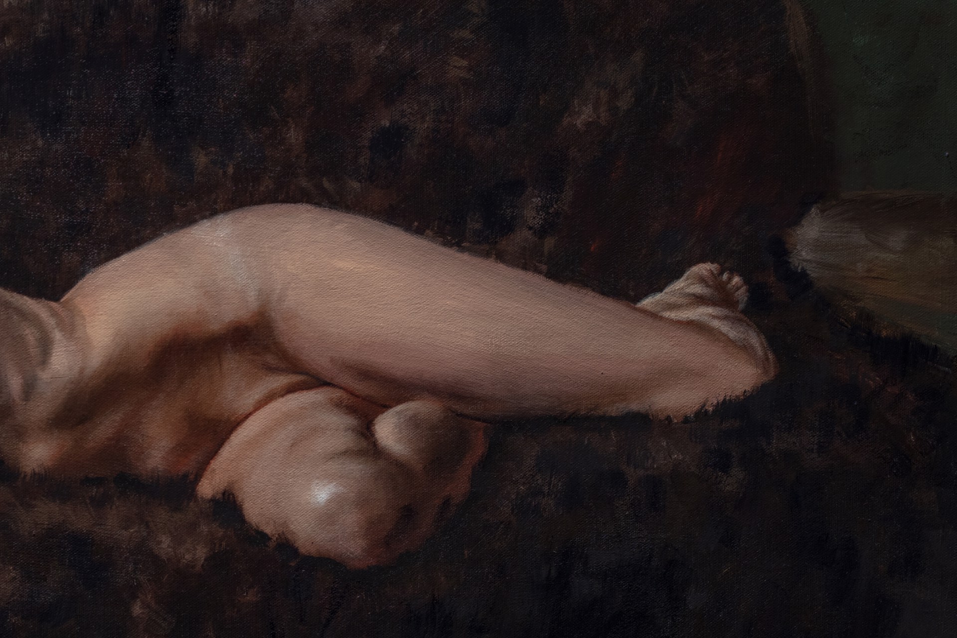 A nude figure rests on a dark sofa with a white sheet nearby.