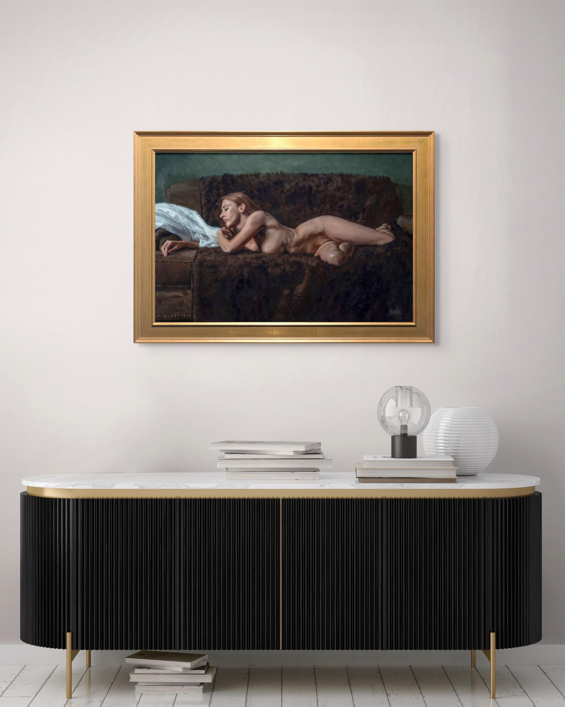 A nude figure rests on a dark sofa with a white sheet nearby.