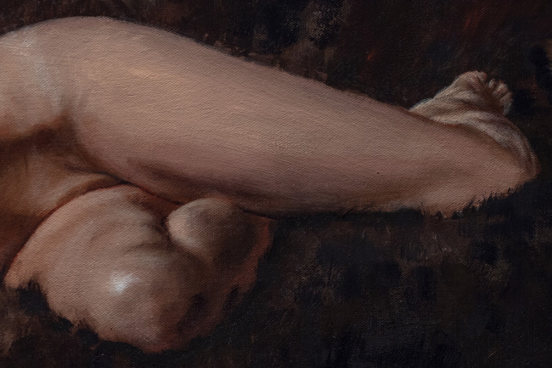 A nude figure rests on a dark sofa with a white sheet nearby.