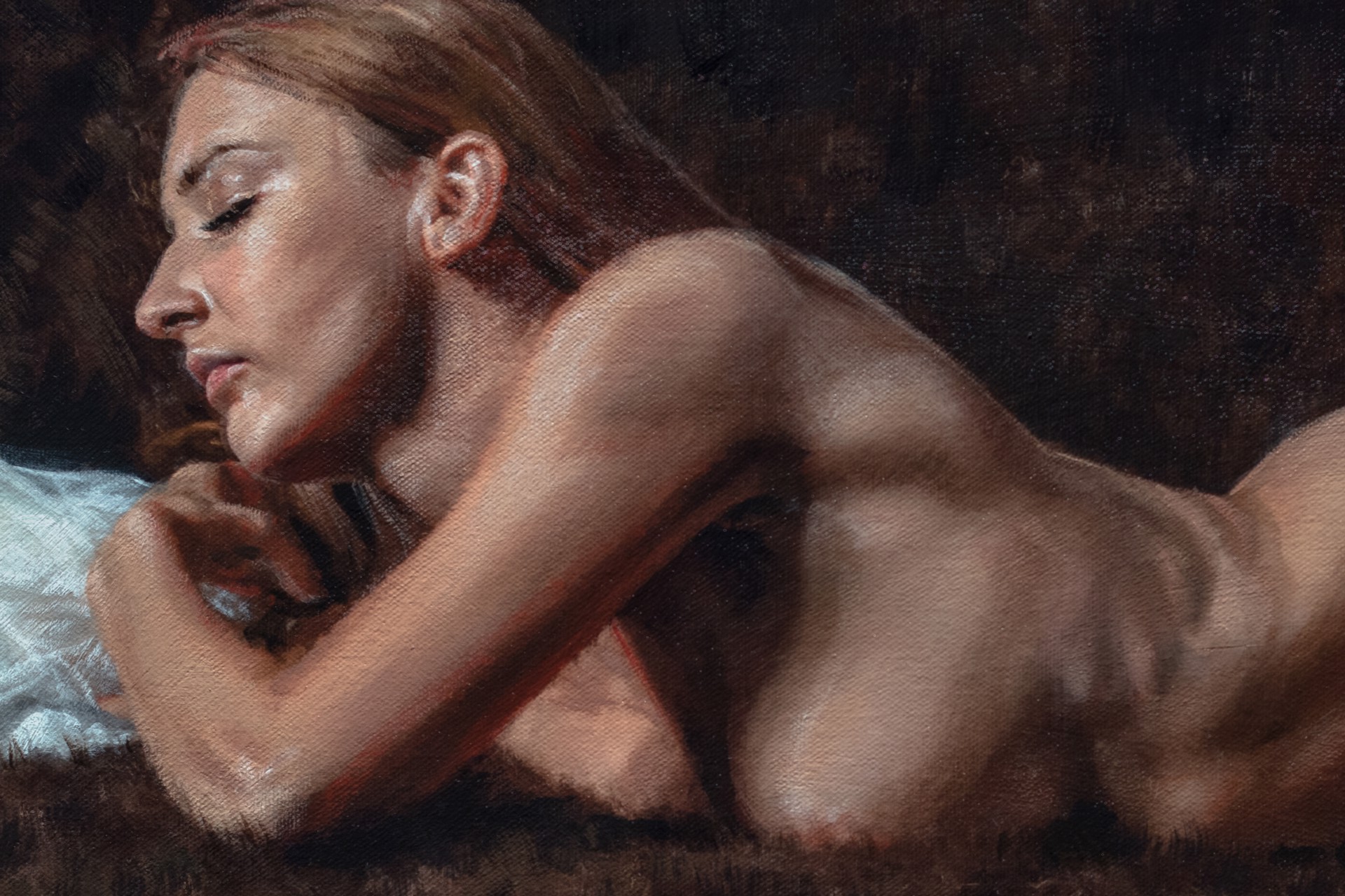 A nude figure rests on a dark sofa with a white sheet nearby.