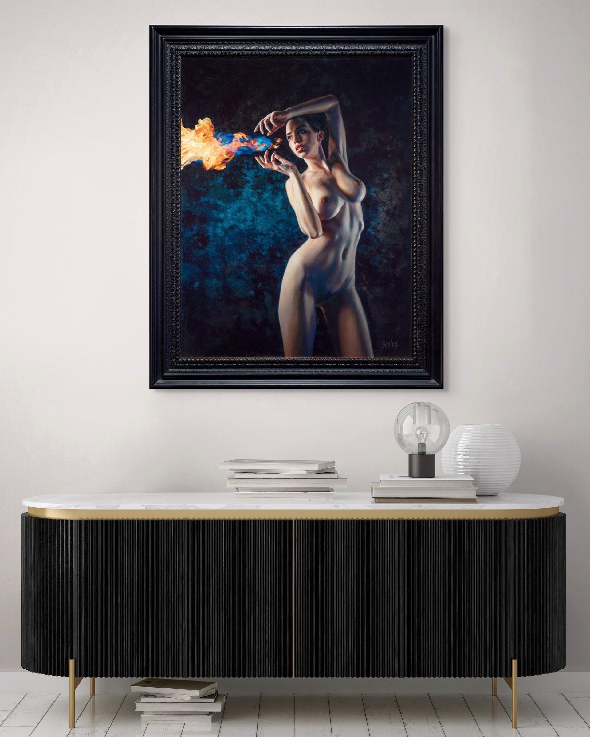 A nude figure stands in a dramatic pose, holding a stream of blue and orange flames.