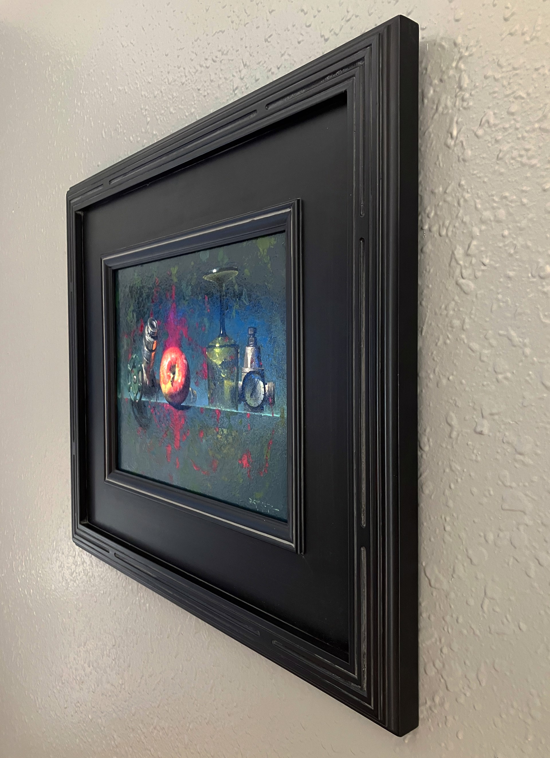 A still life painting featuring industrial and organic objects arranged on a reflective surface.