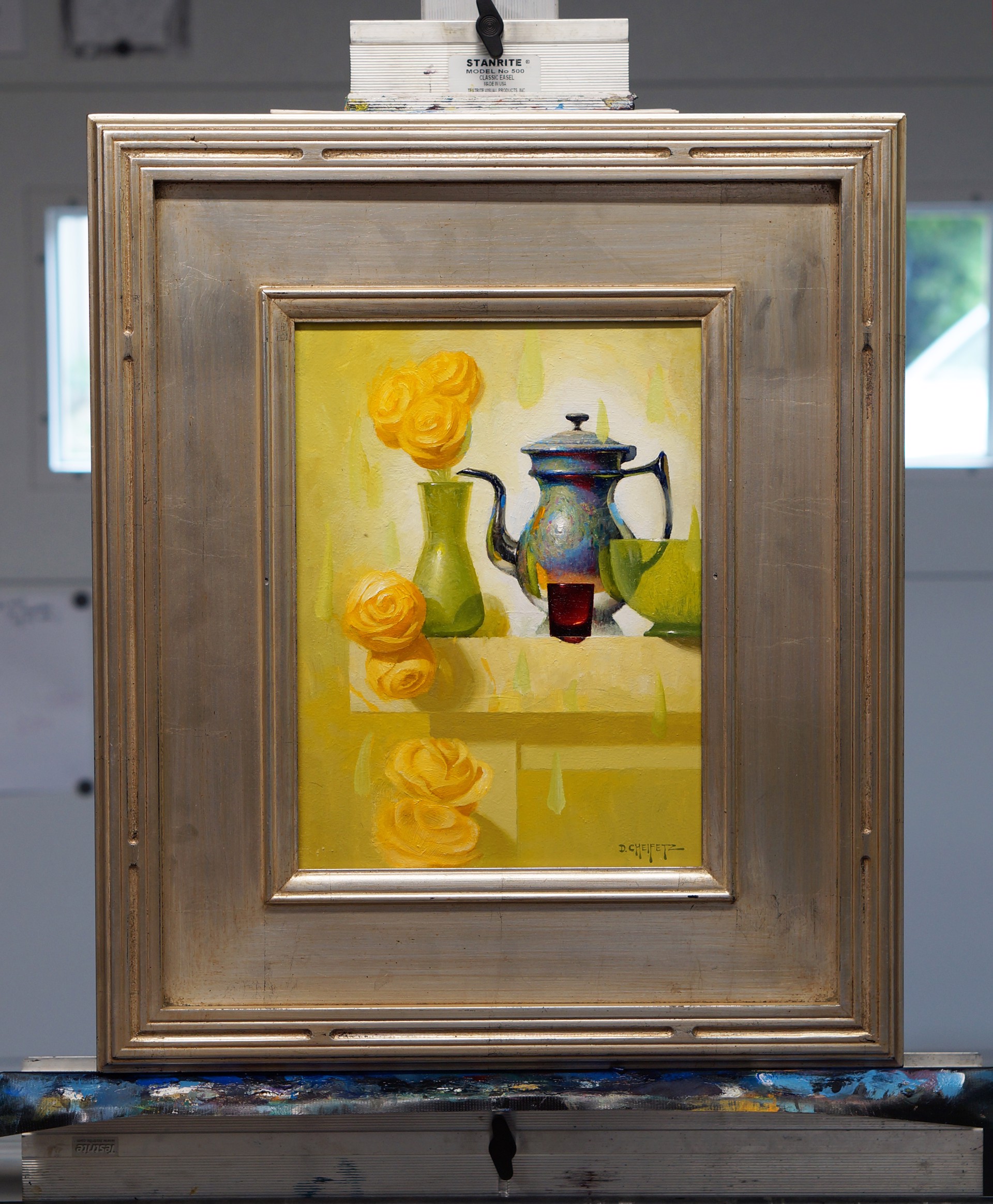 A still life painting featuring a metallic teapot, green vase with yellow roses, and abstract shapes on a light background.