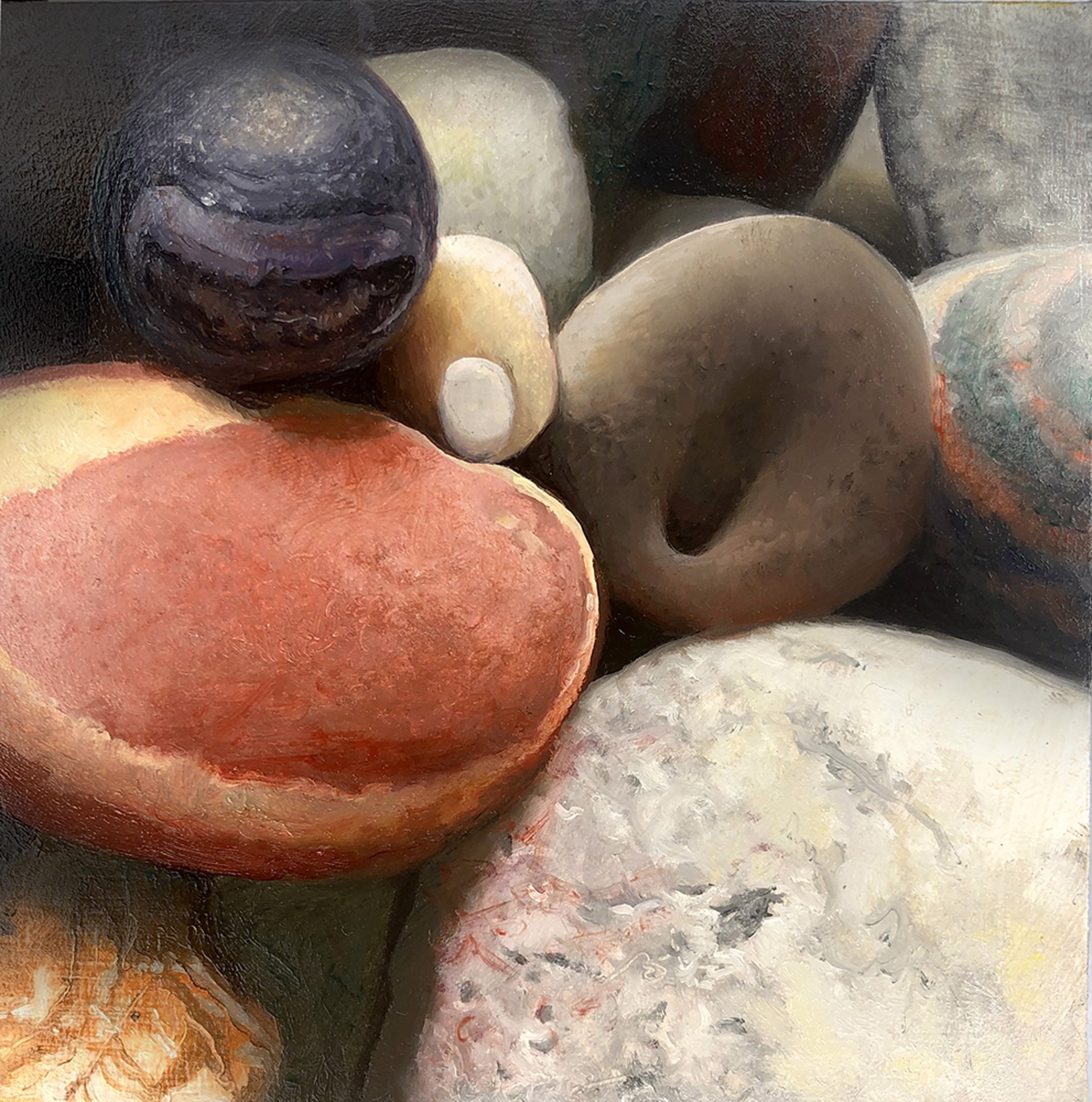 A close-up still life of smooth, rounded stones in warm earth tones.