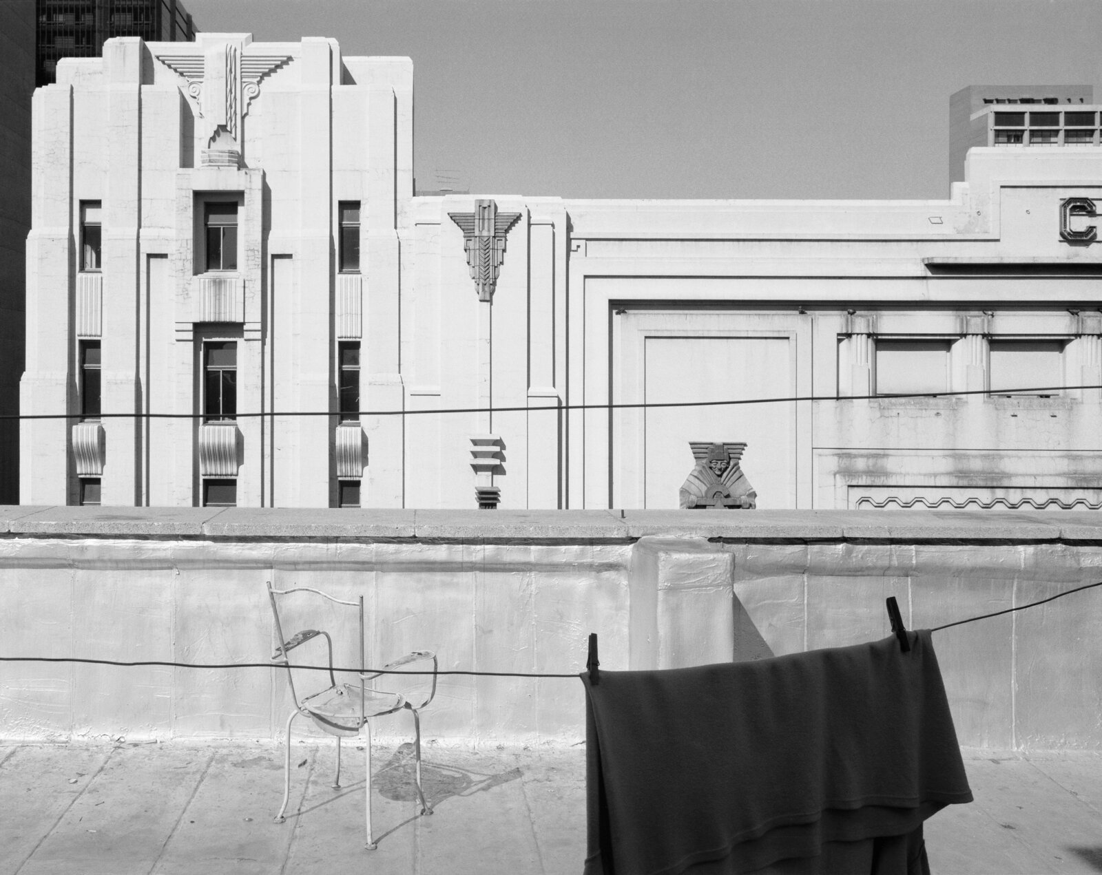 A black and white photo of a chair and a chair on a balcony.