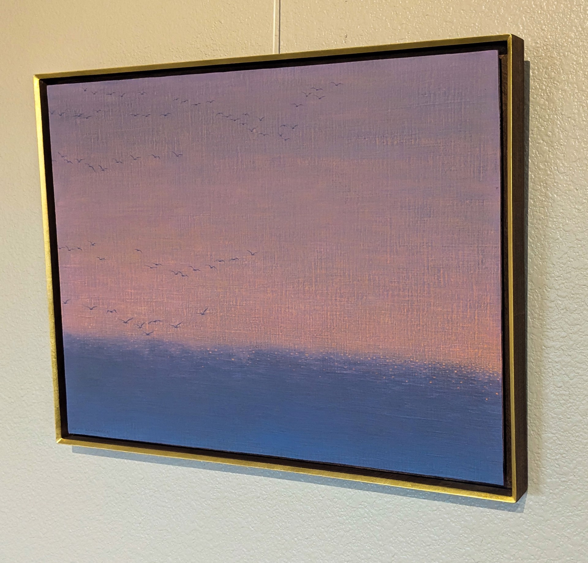 A serene seascape painting featuring a flock of birds against a soft, pastel sky.