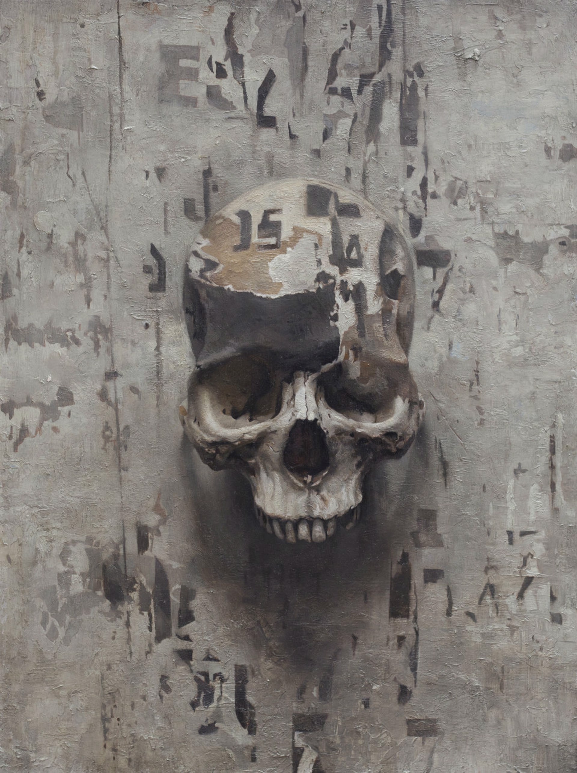 A painting of a skull on a concrete wall.