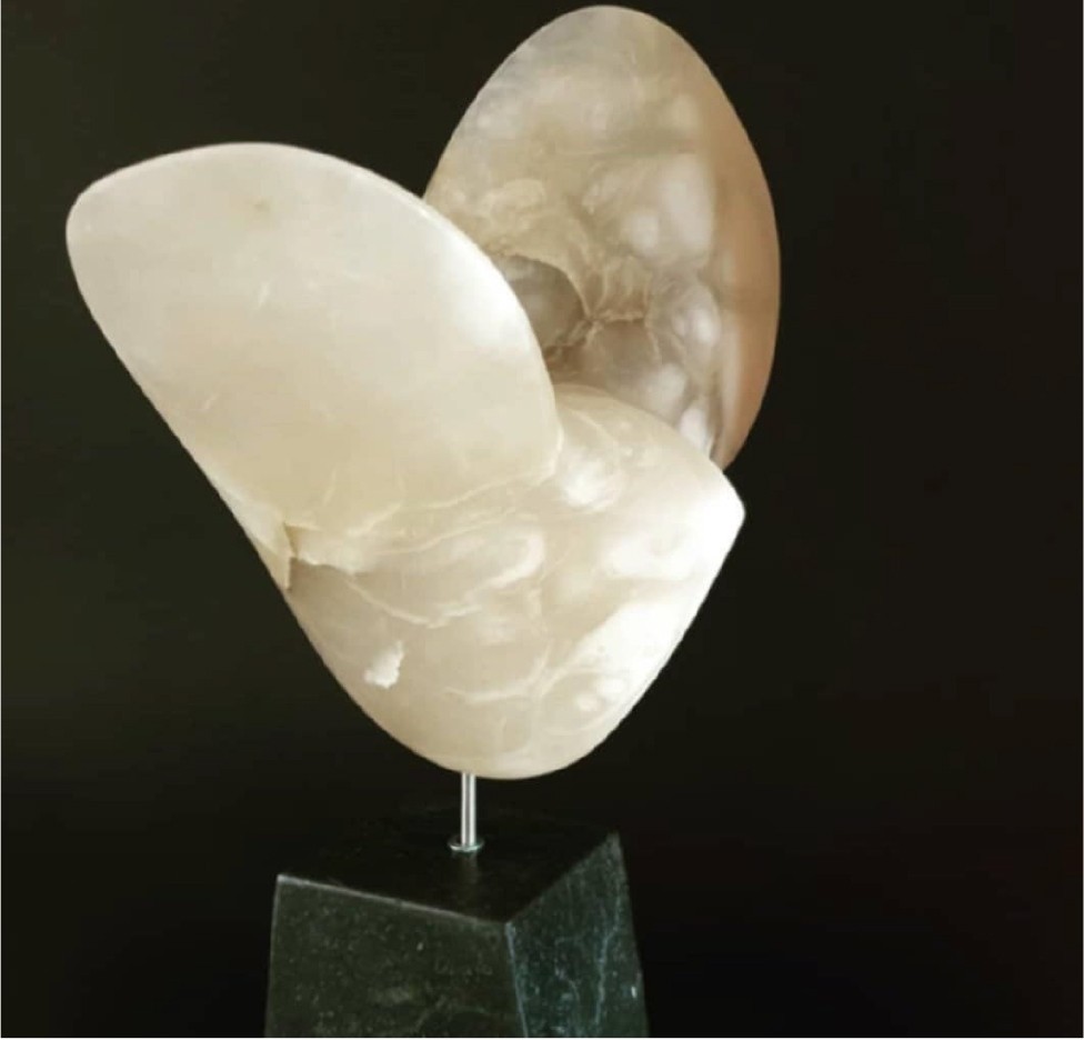 A sculpture of a shell on a marble base.