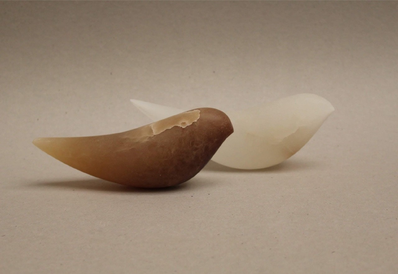 A couple of white and brown objects sitting on top of a table.