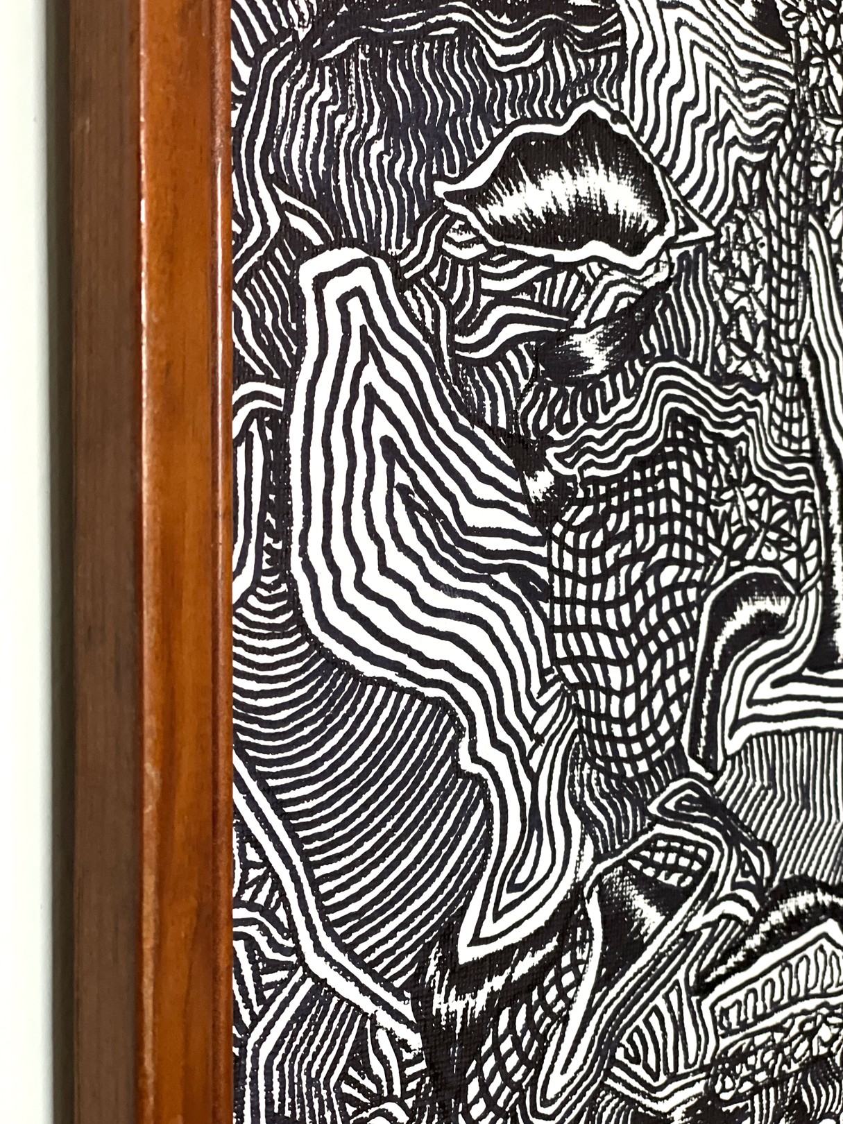 A black and white drawing hanging on a wall.