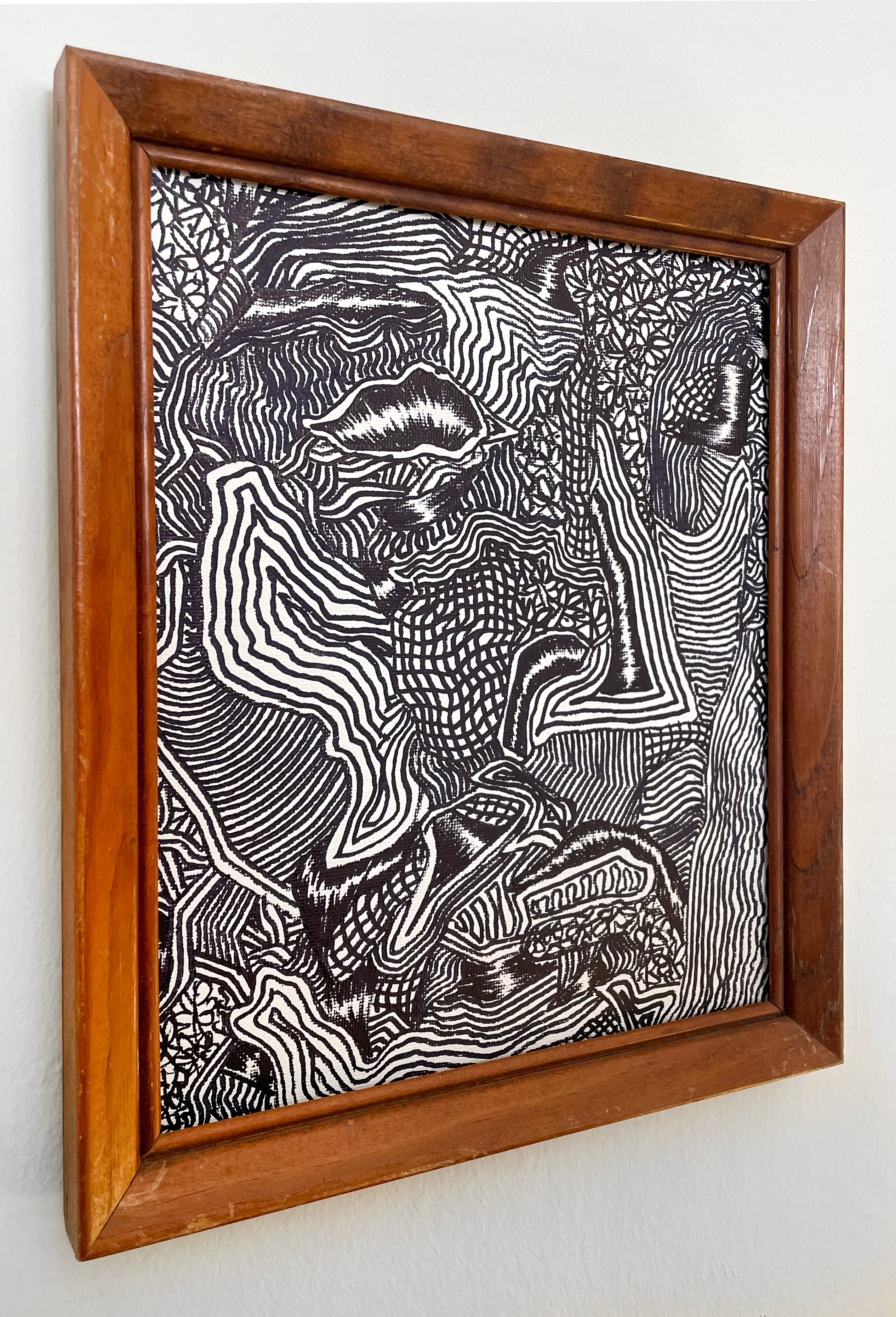 A black and white drawing hanging on a wall.