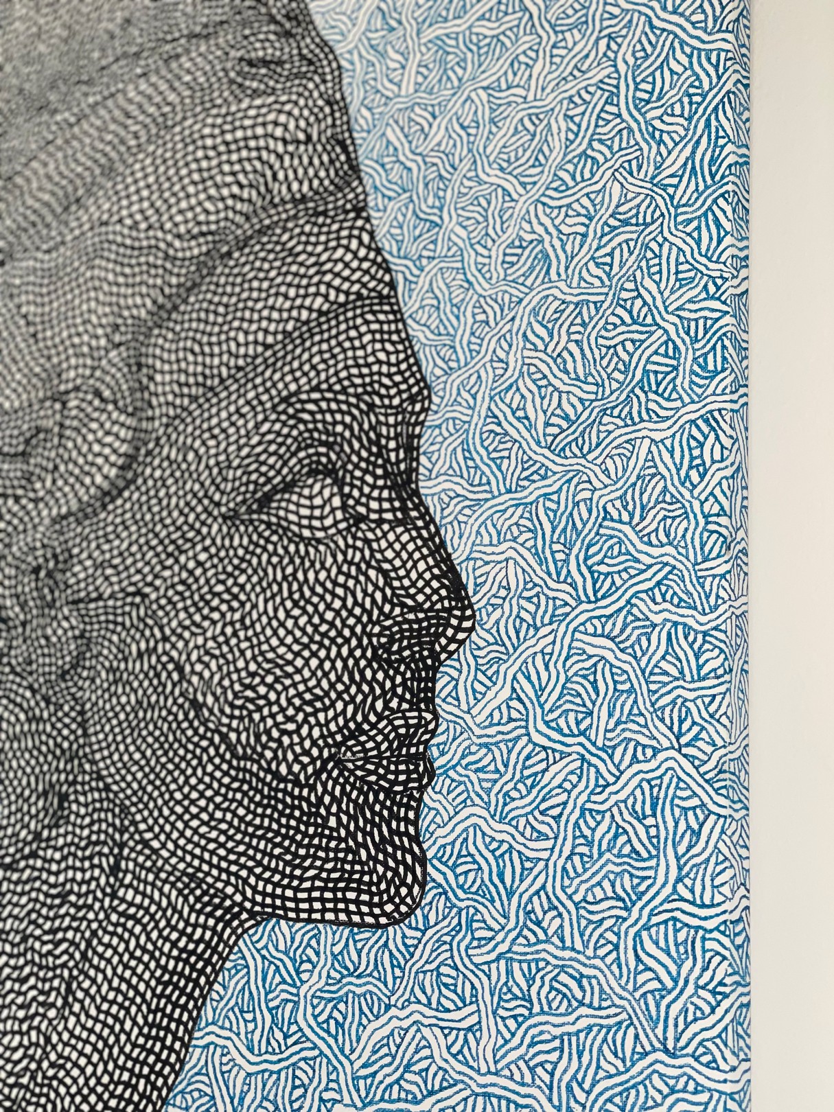 A black and white drawing of a woman's face on a blue background.