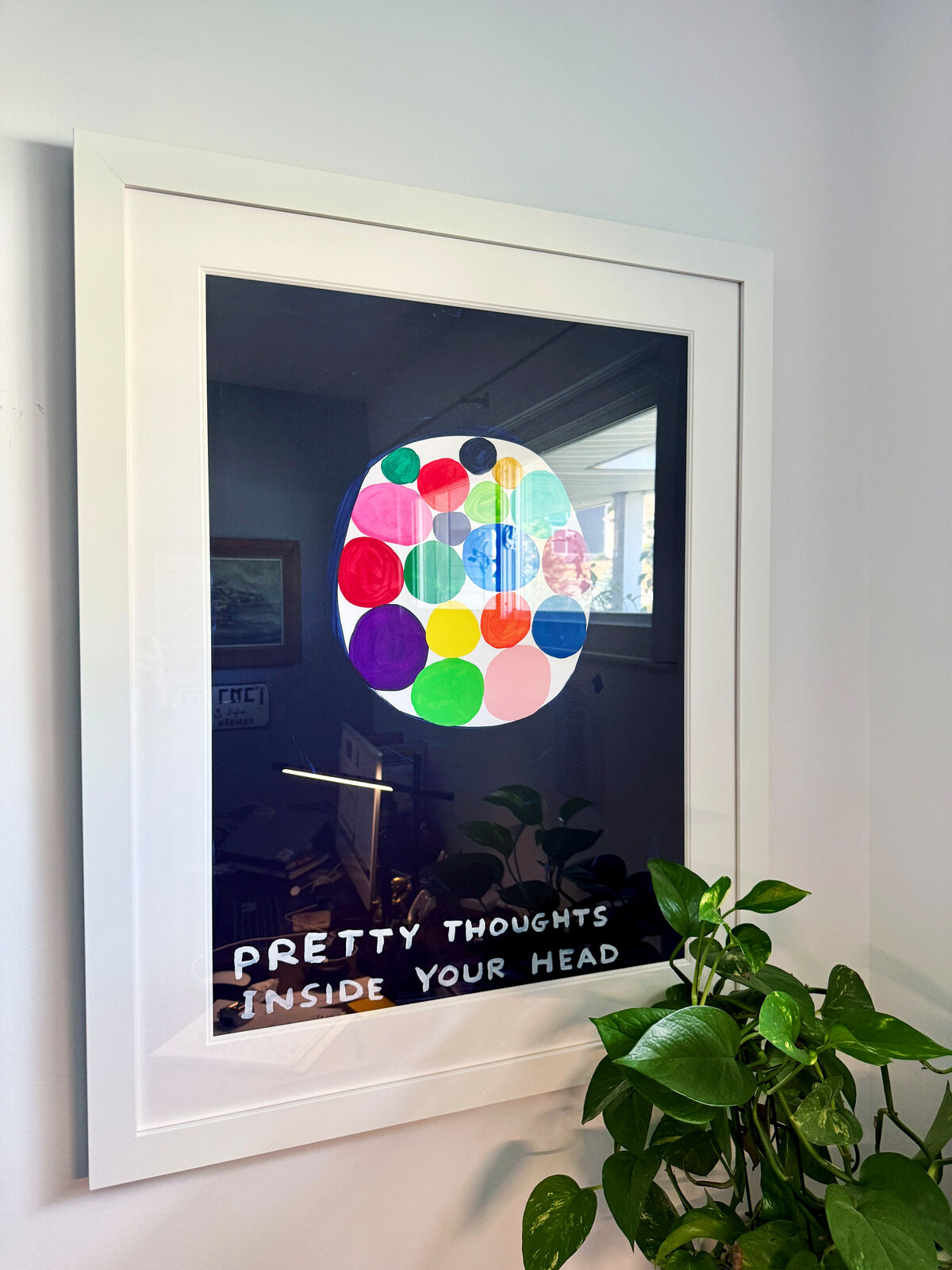 A picture of a painting with the words pretty thoughts inside your head.