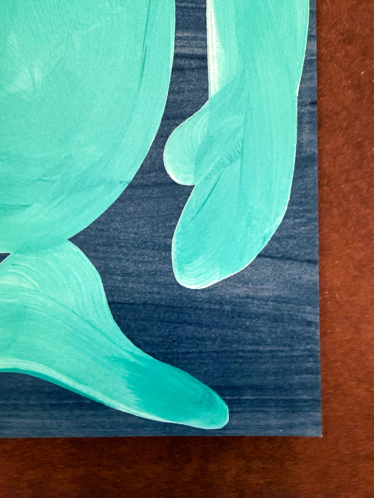 A blue painting of a nude woman sitting on the ground.