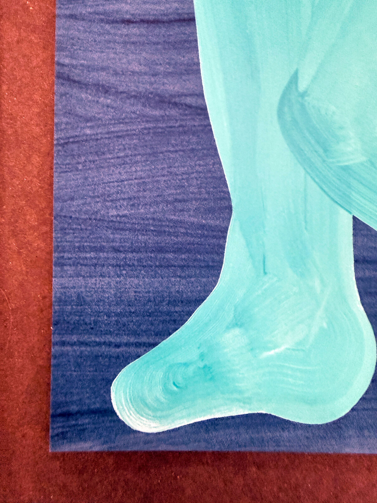 A blue painting of a nude woman sitting on the ground.