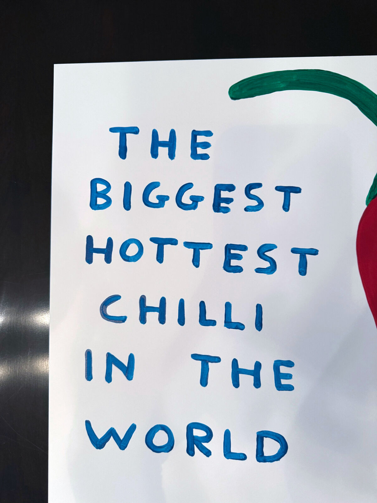 A red chili pepper with the words the biggest hottest chili in the world.