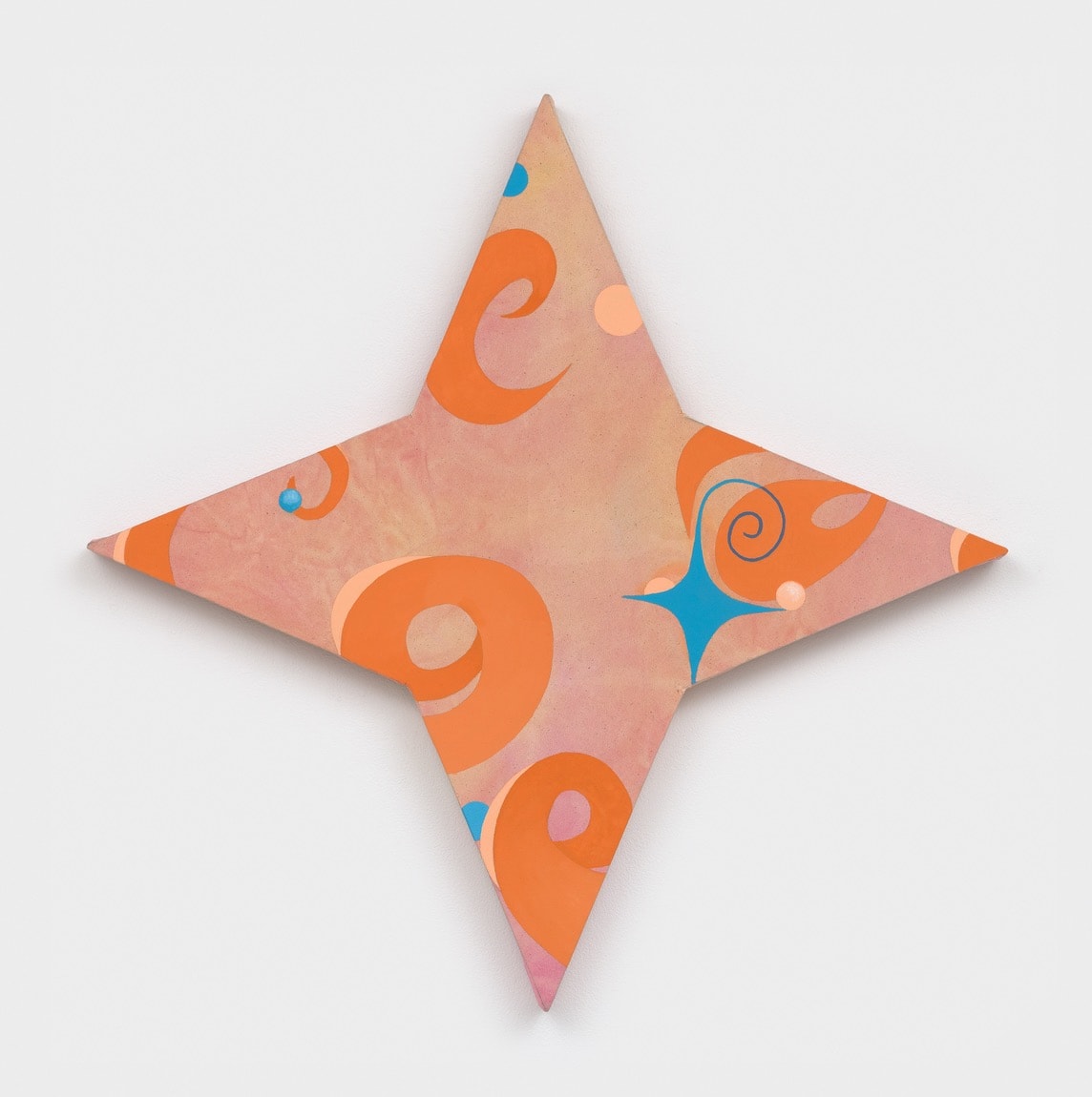 A star shaped object on a white surface. 