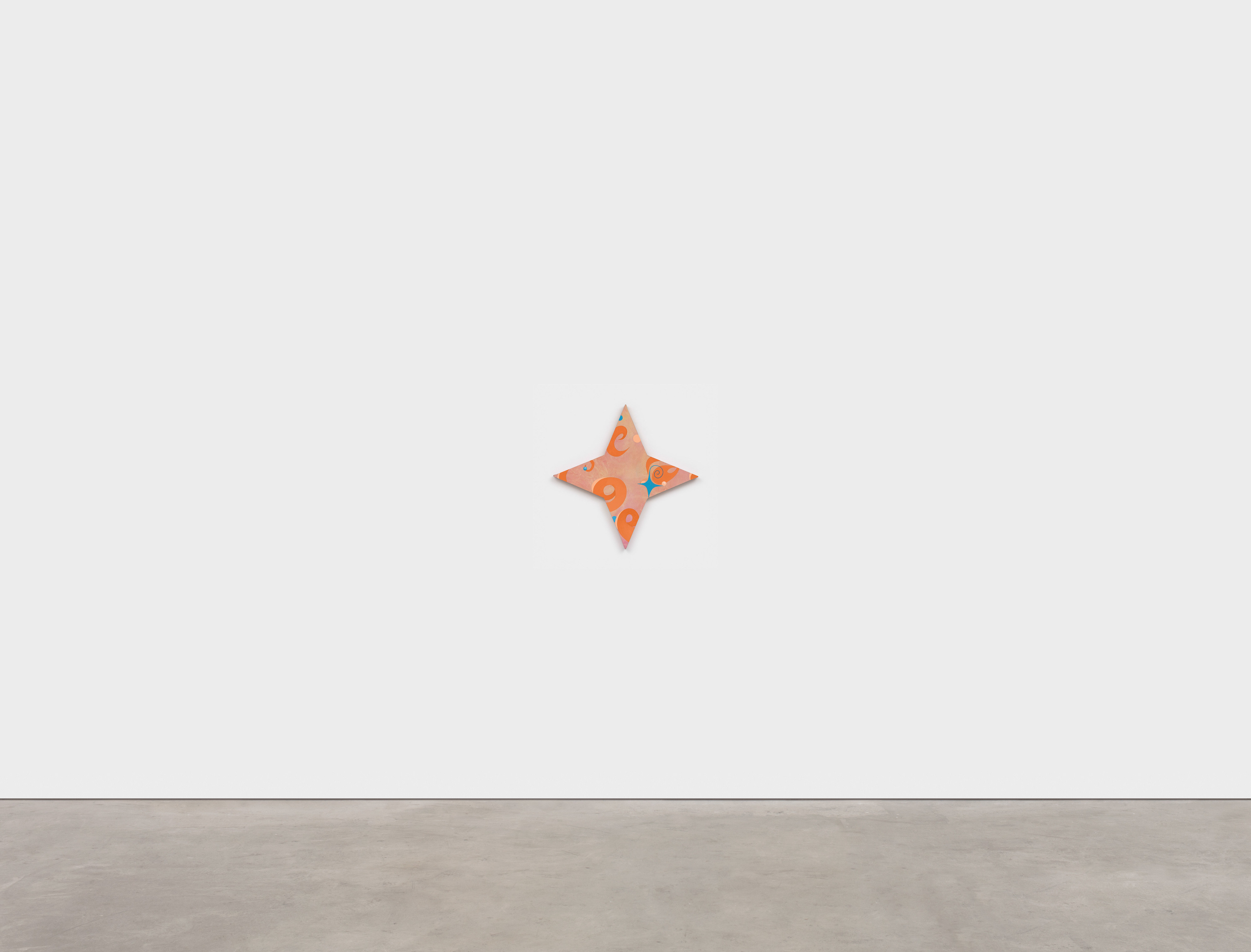 A star shaped object on a white surface. 