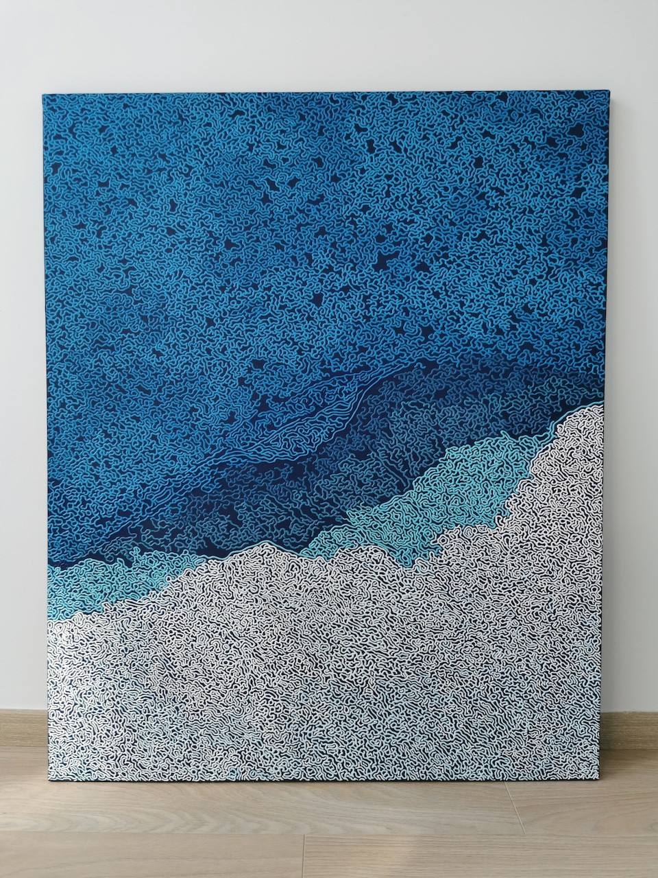 A blue and white abstract background with a pattern of clouds.