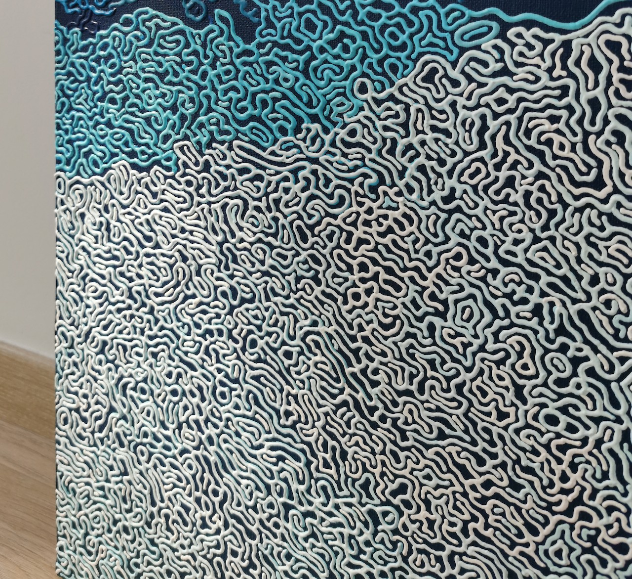 A blue and white abstract background with a pattern of clouds.