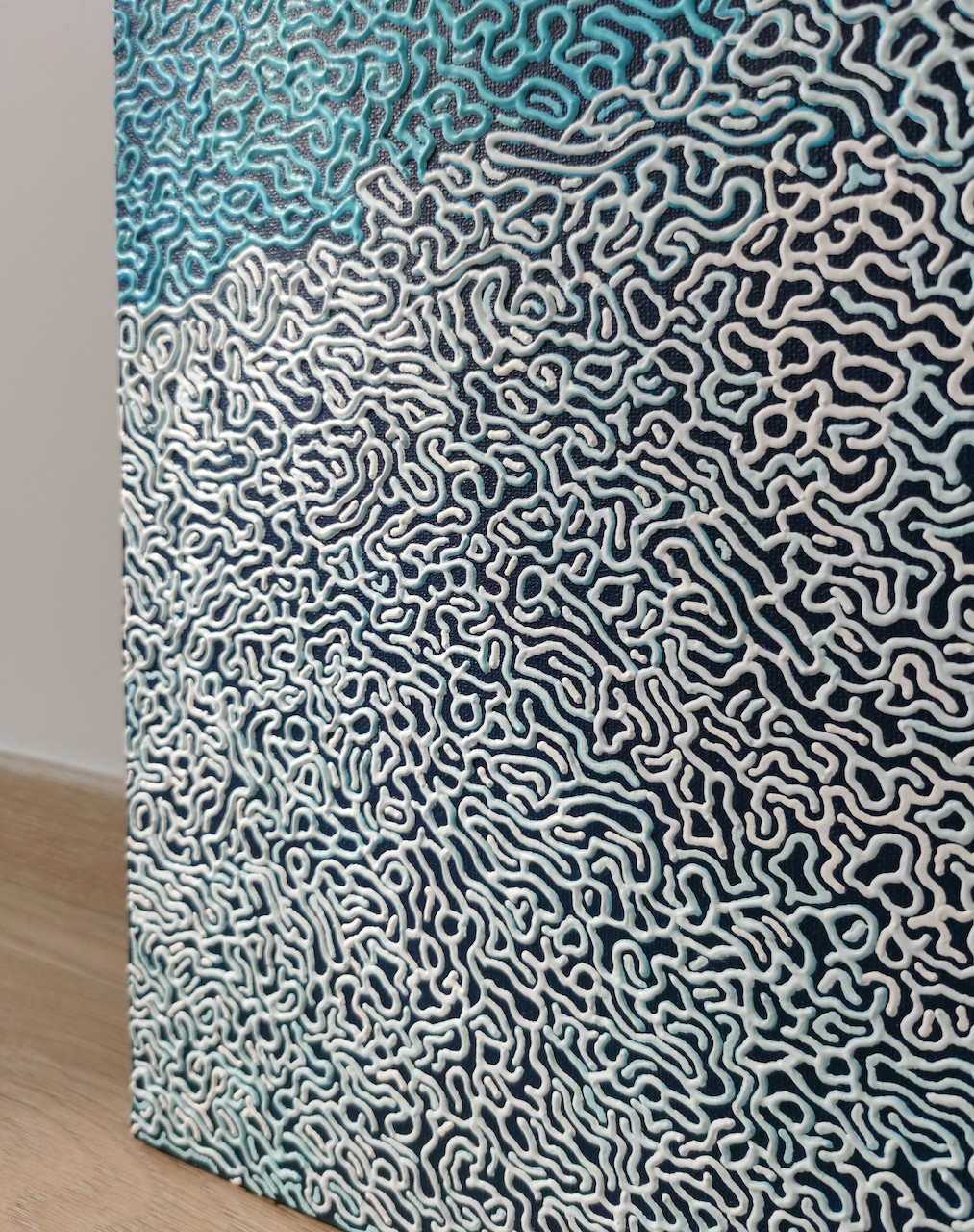 A blue and white abstract background with a pattern of clouds.