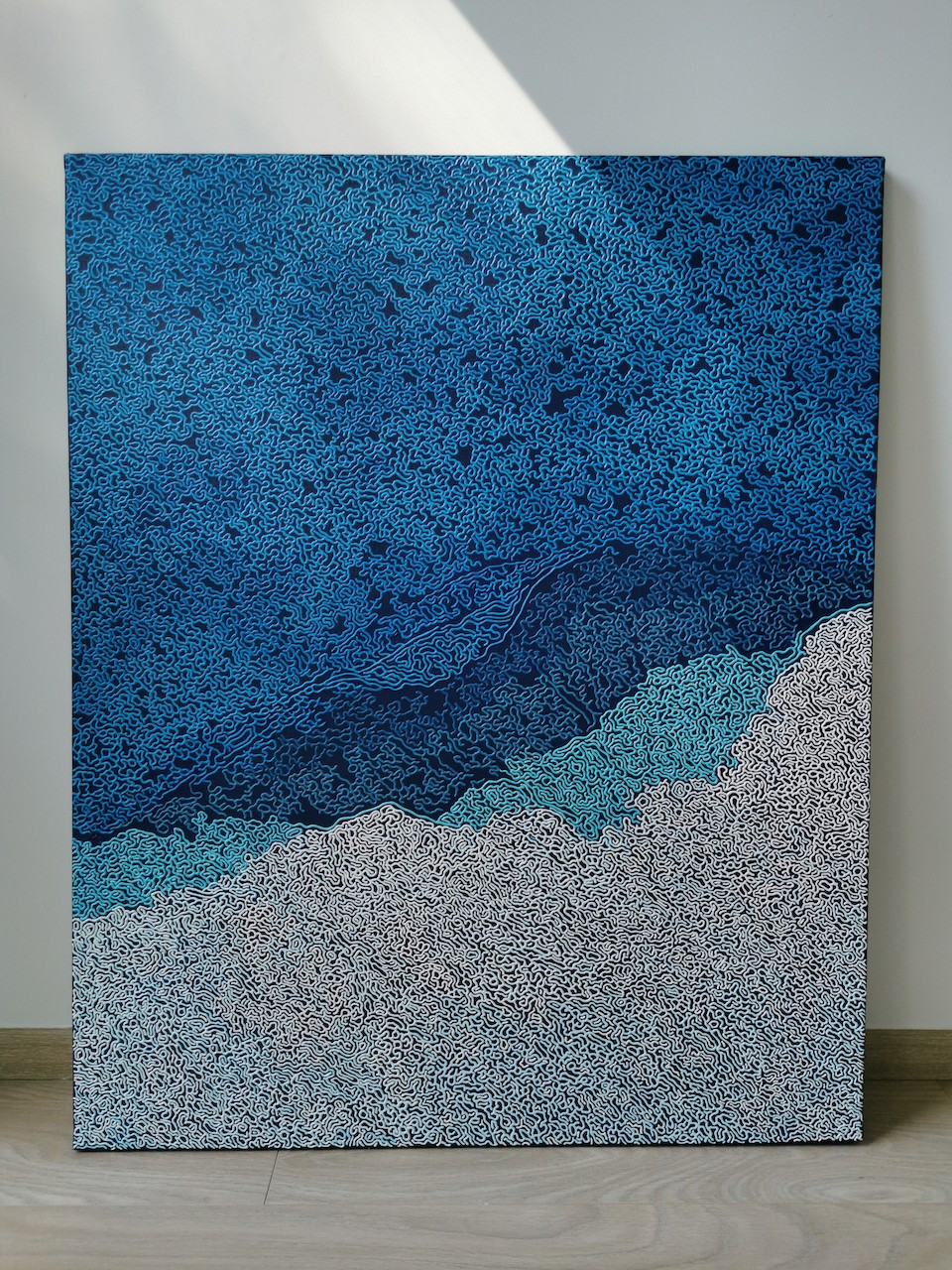 A blue and white abstract background with a pattern of clouds.