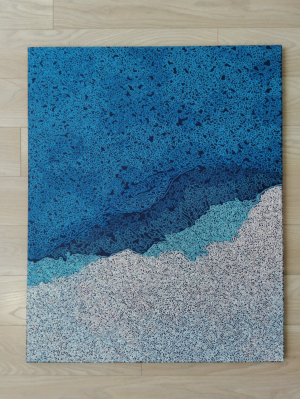 A blue and white abstract background with a pattern of clouds.