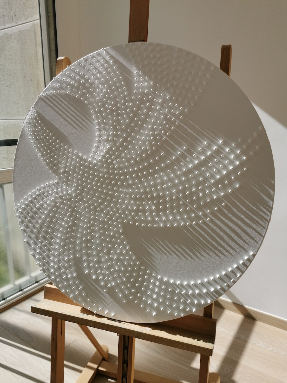 A large white plate sitting on top of a wooden stand.