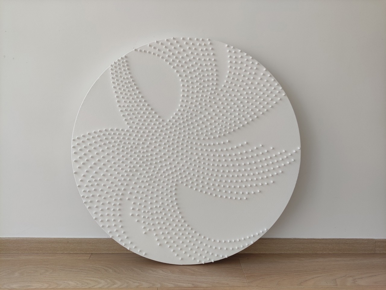 A large white plate sitting on top of a wooden stand.