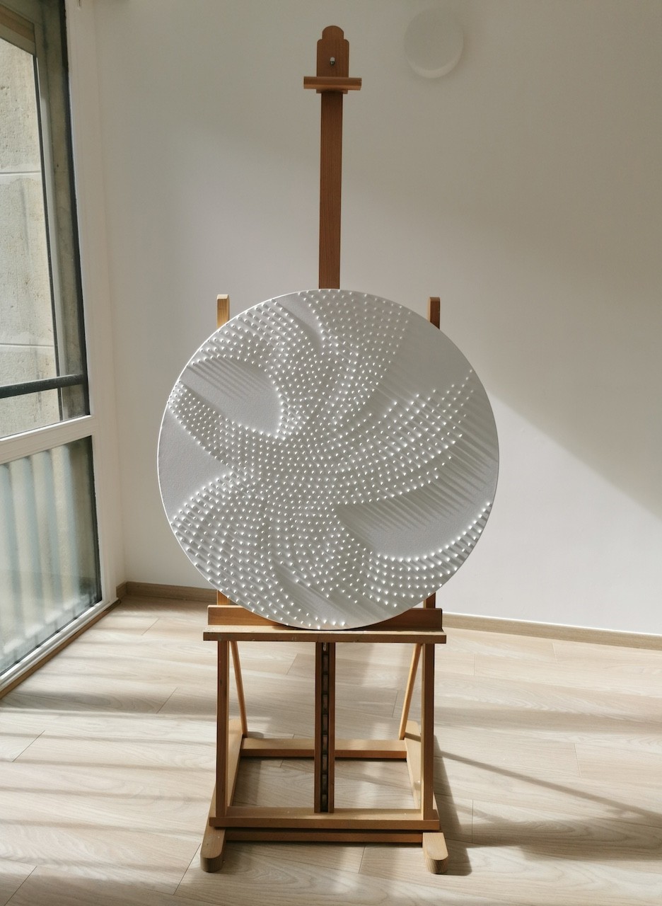 A large white plate sitting on top of a wooden stand.