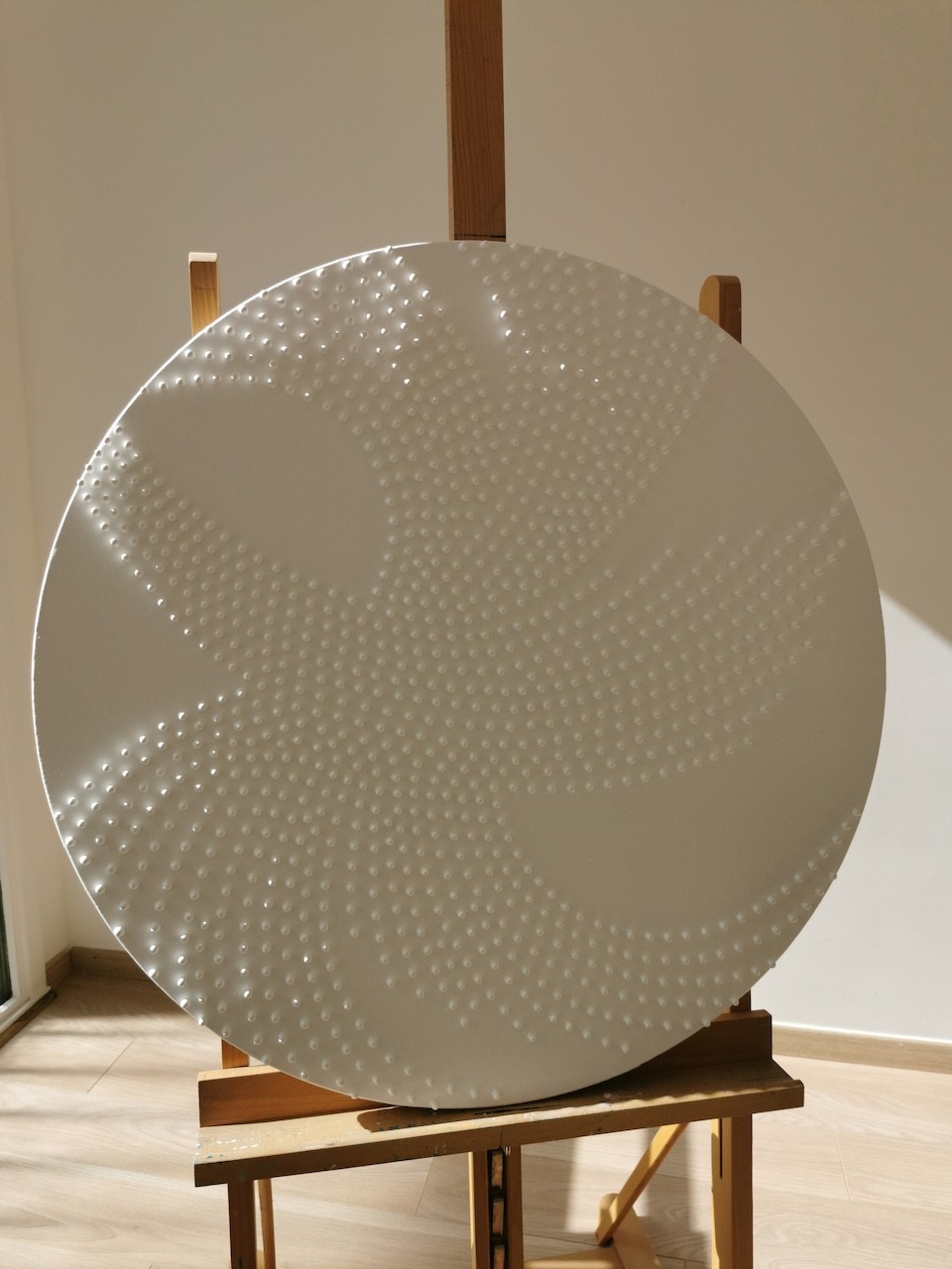 A large white plate sitting on top of a wooden stand.
