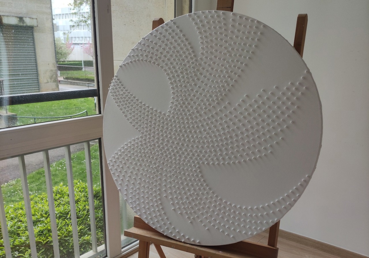 A large white plate sitting on top of a wooden stand.