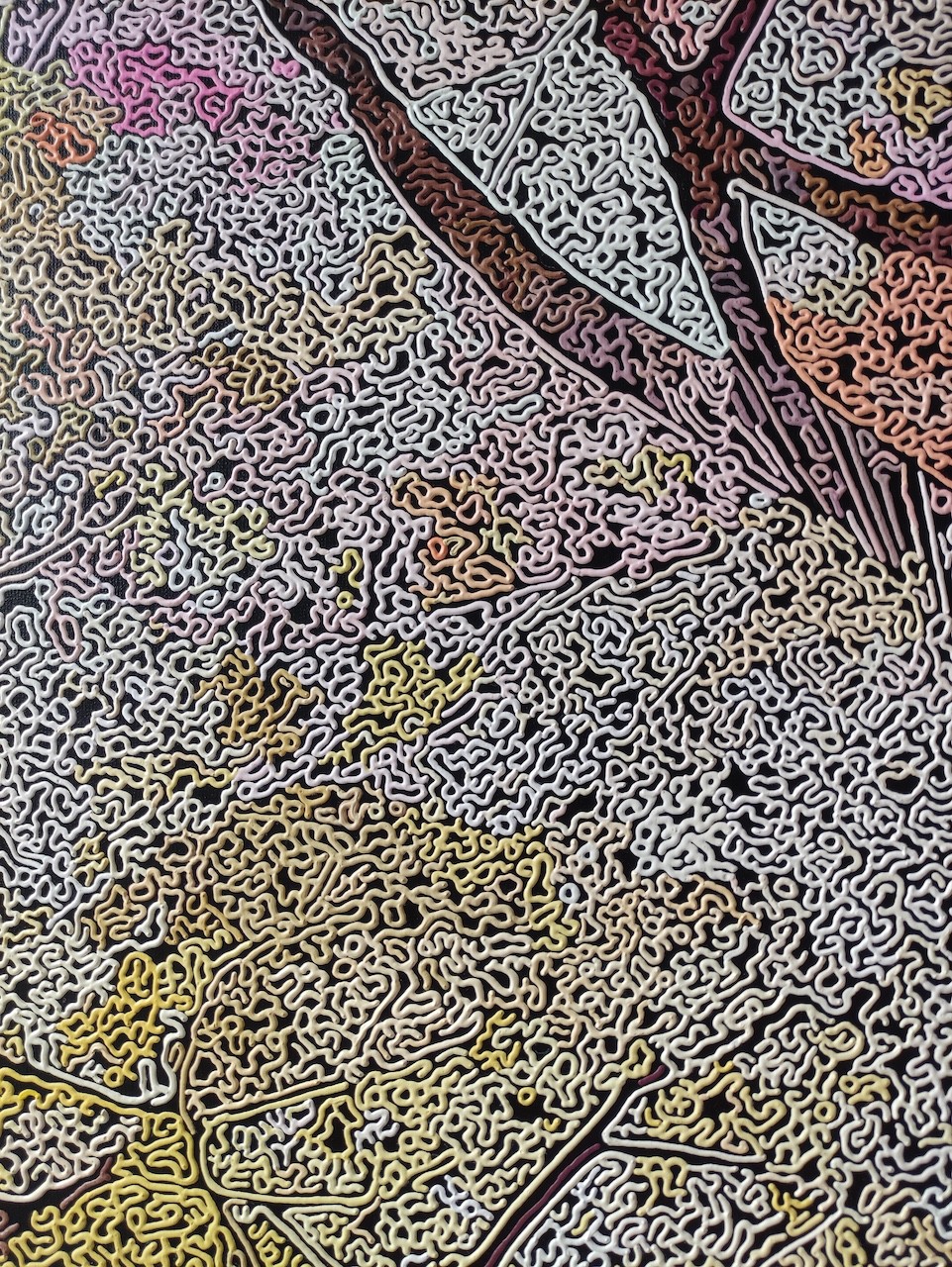 A painting of a tree on a wall in a room.