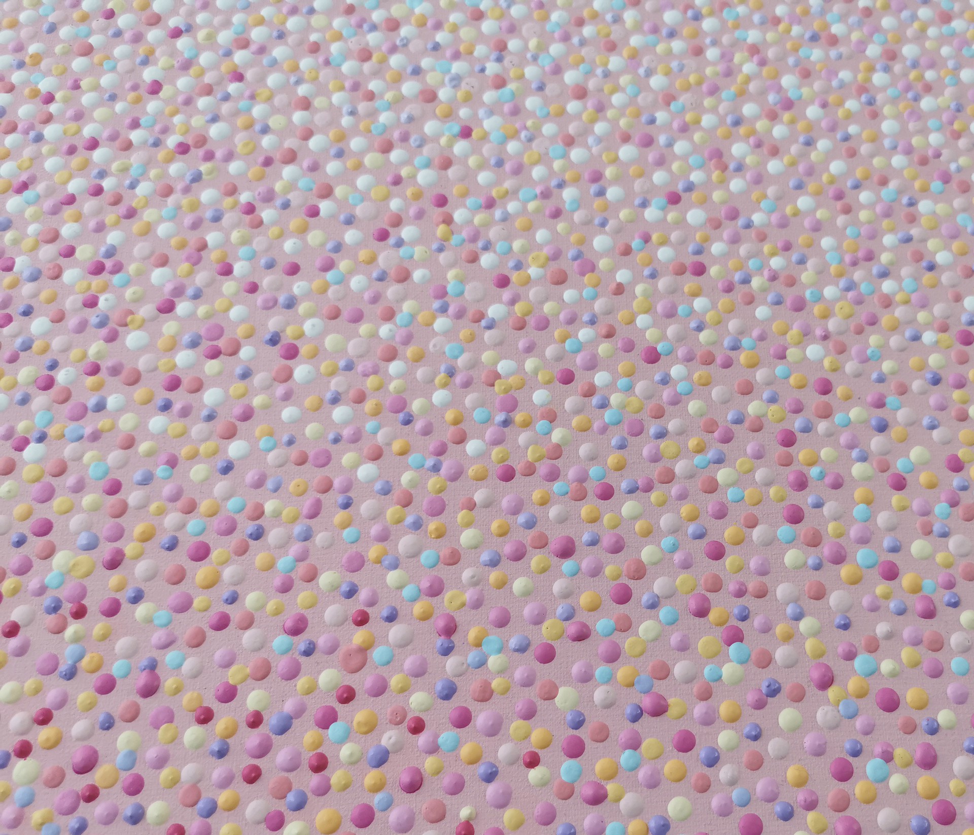 A close up of a pink fabric with small dots on it.
