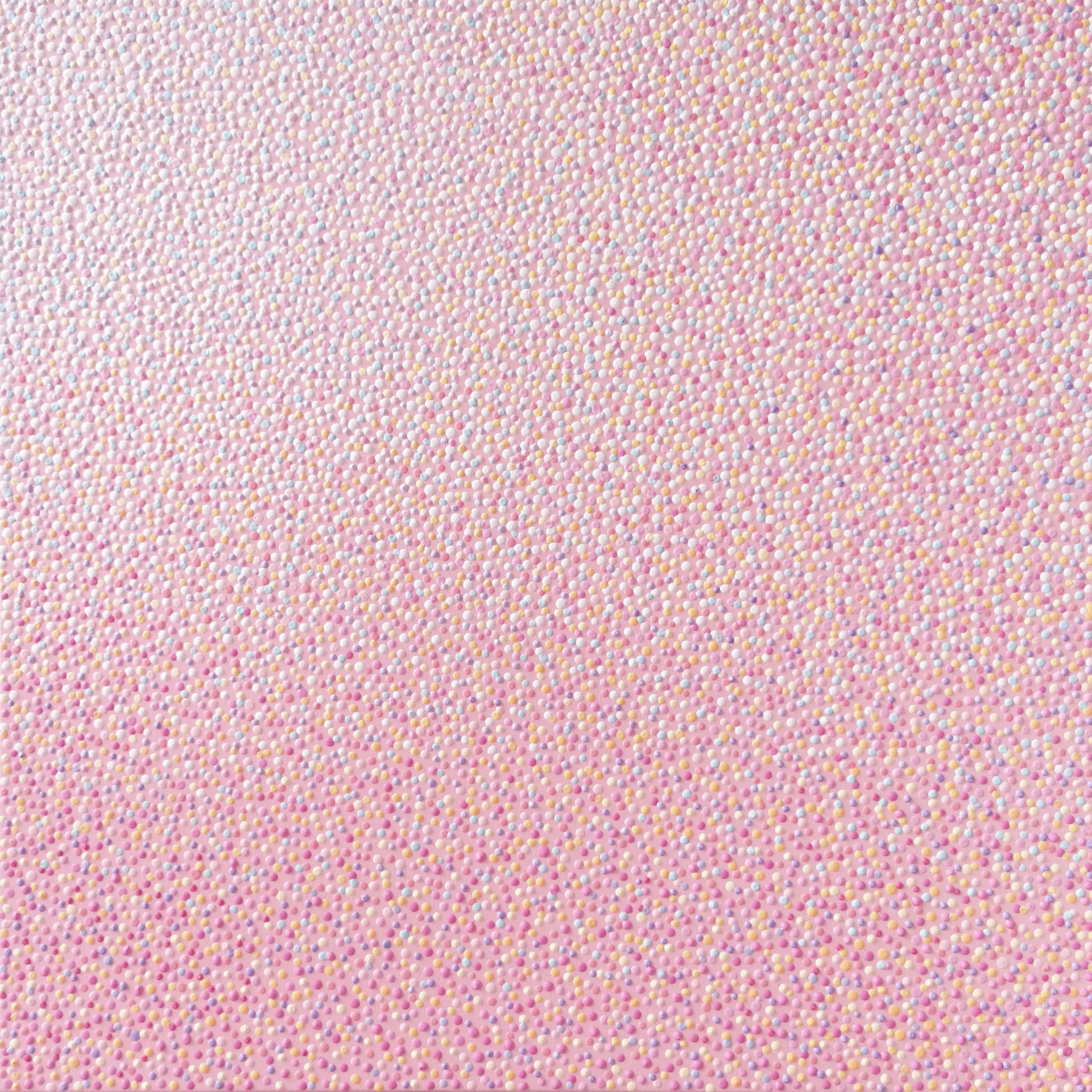 A close up of a pink fabric with small dots on it.