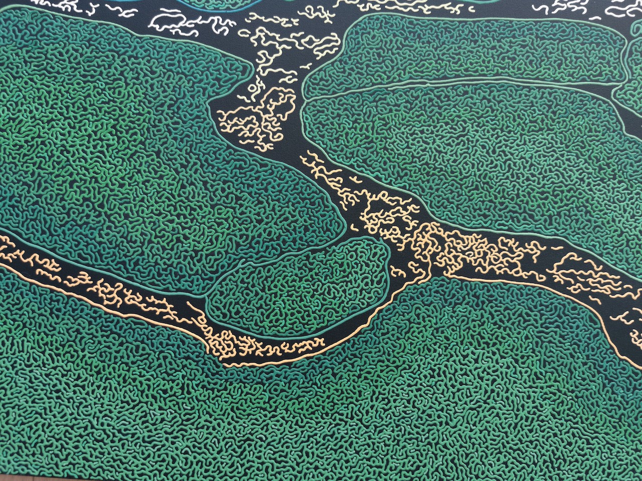 A large painting on a wall in a room.