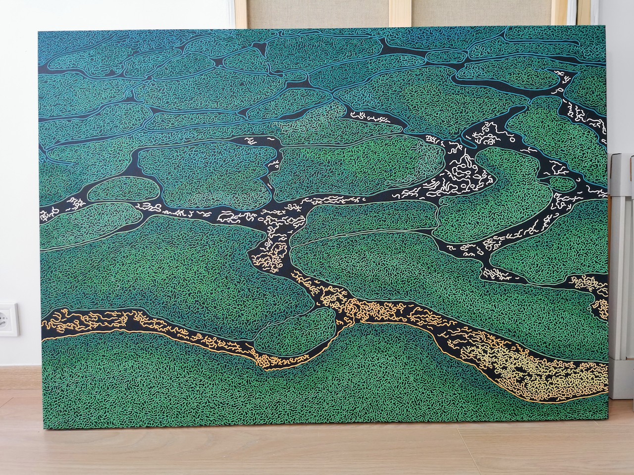 A large painting on a wall in a room.