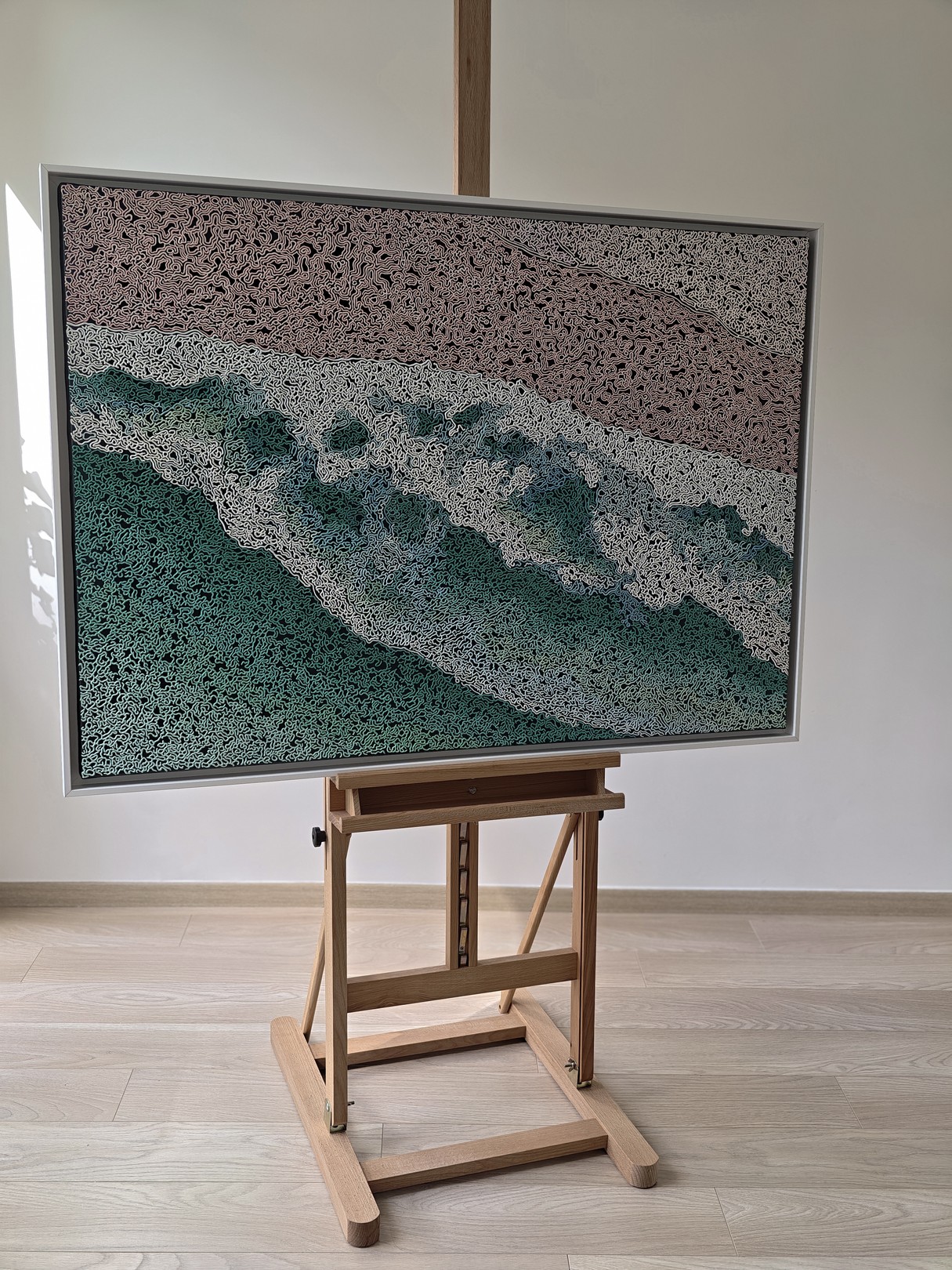 A rug on a wooden floor with a painting on it.