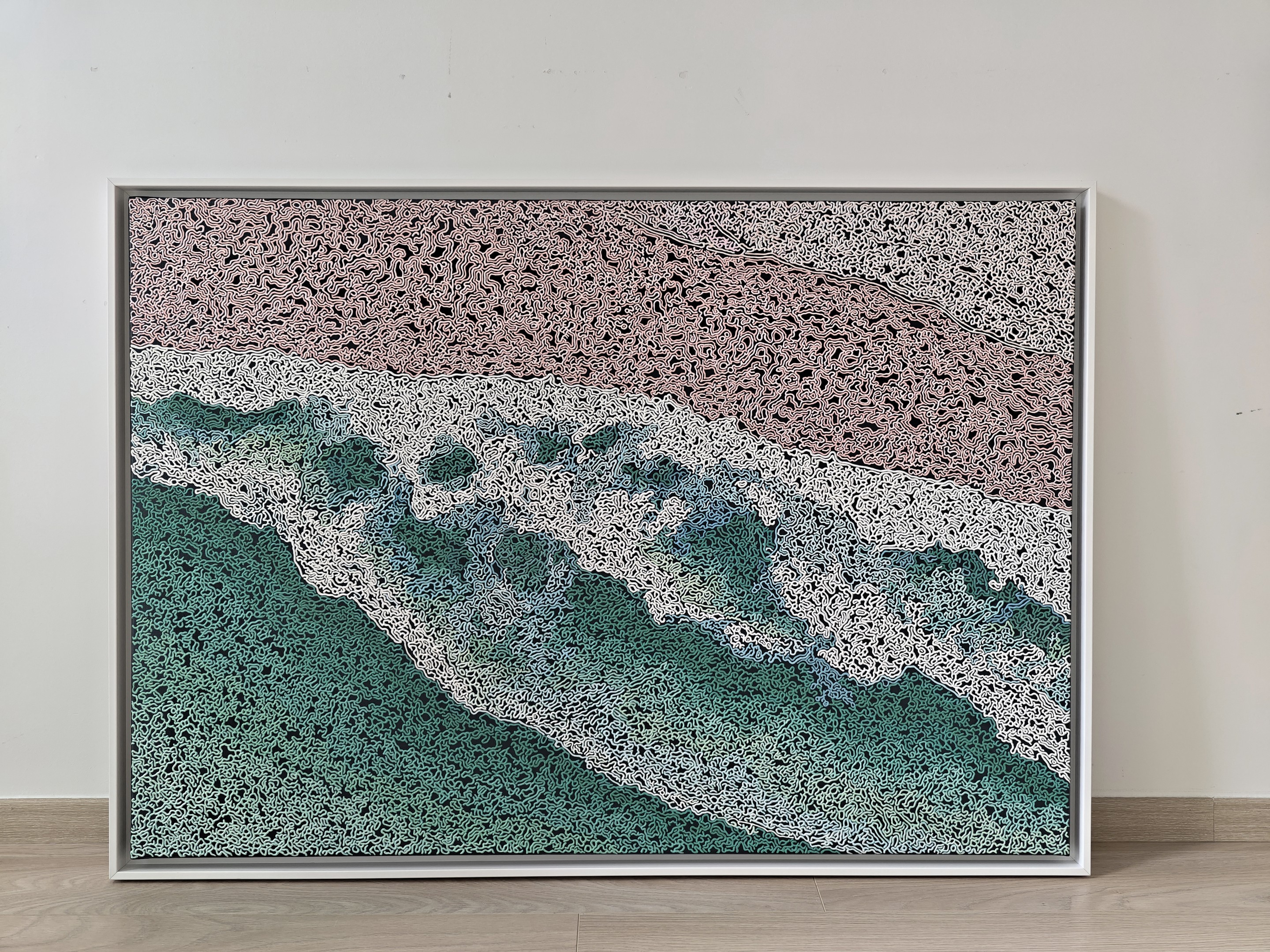 A rug on a wooden floor with a painting on it.