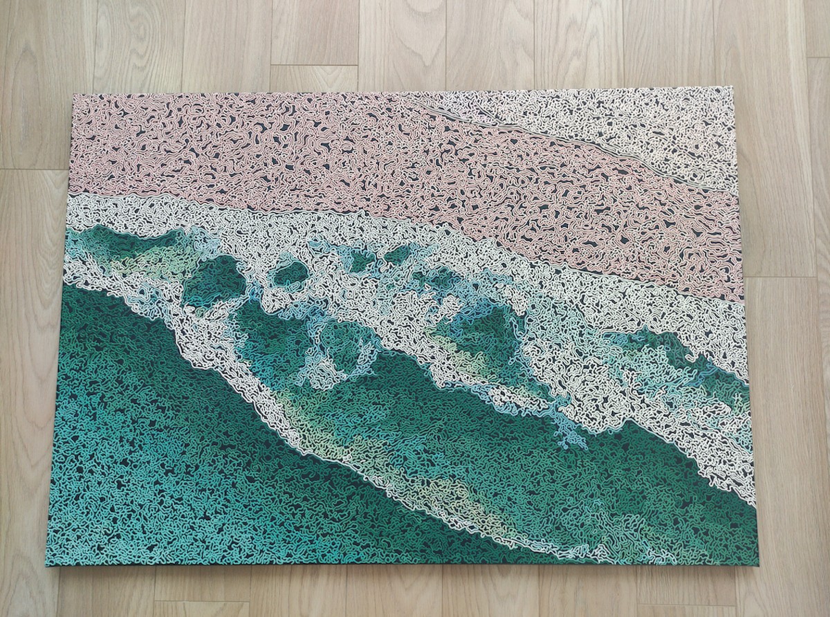 A rug on a wooden floor with a painting on it.
