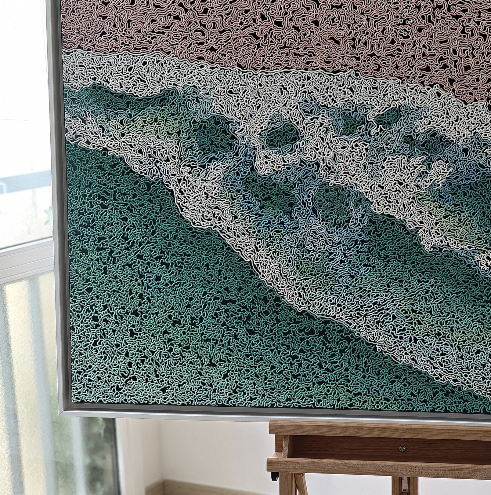 A rug on a wooden floor with a painting on it.