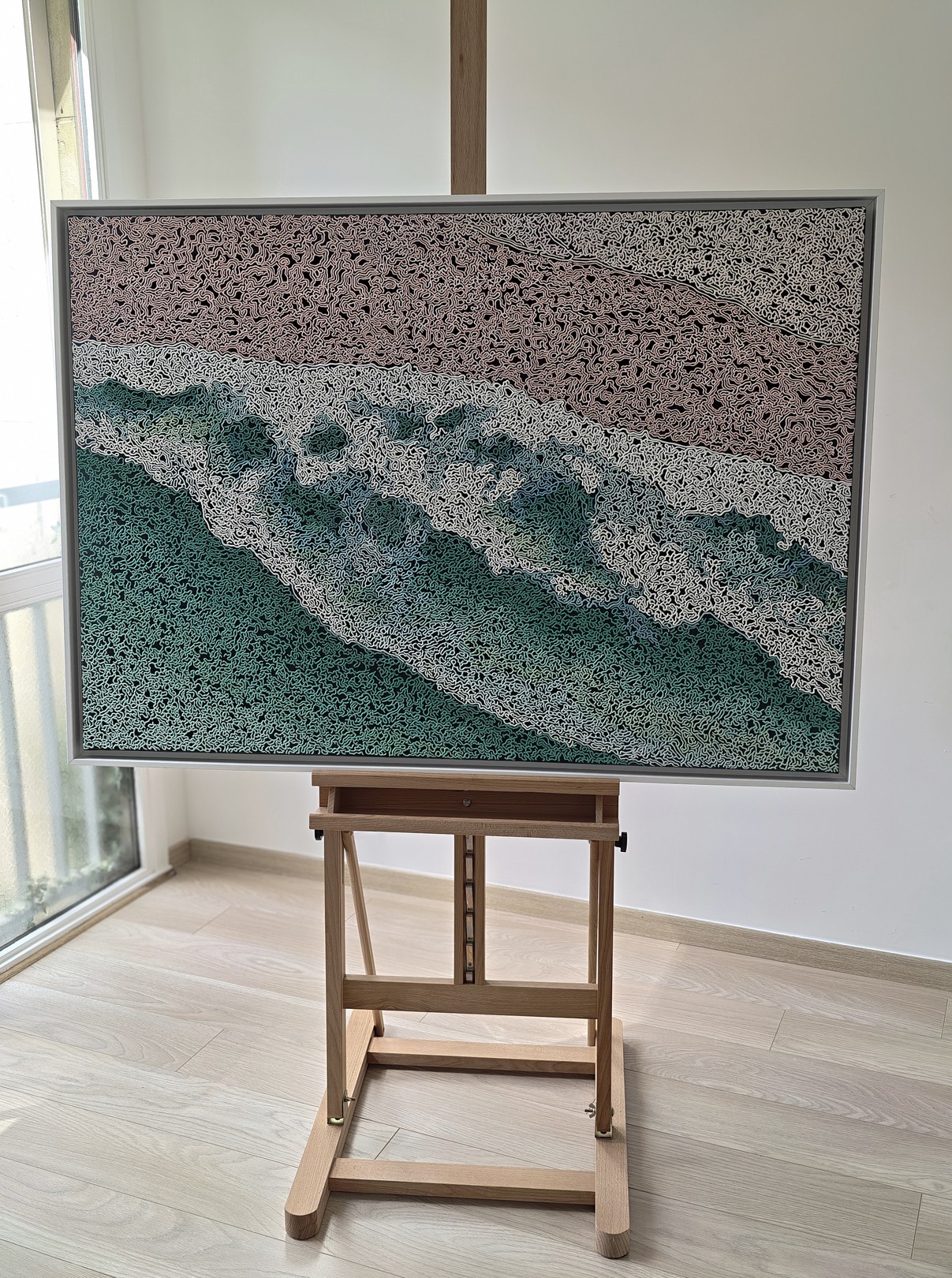 A rug on a wooden floor with a painting on it.