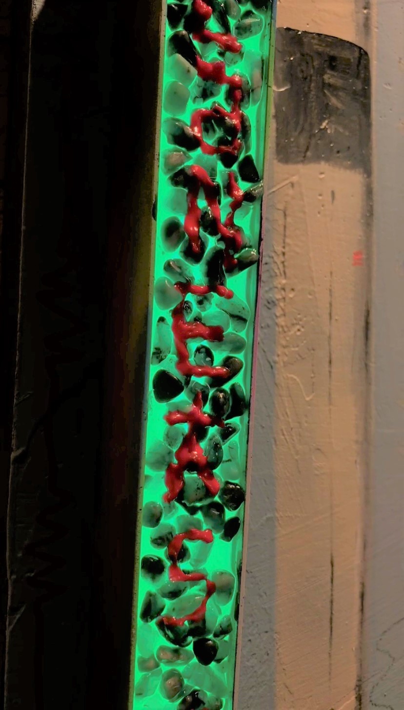 A sign that says worm holes on the side of a building.