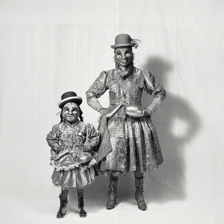 A couple of clowns standing next to each other on a white background.